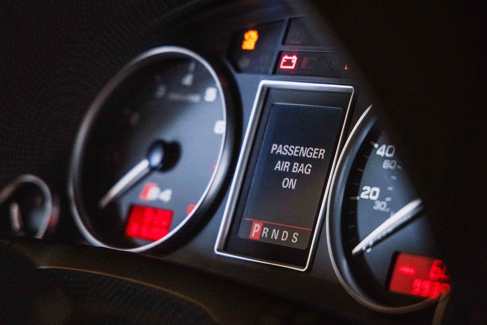 Instrument cluster of vehicle with Passenger Air Bag On words illuminated