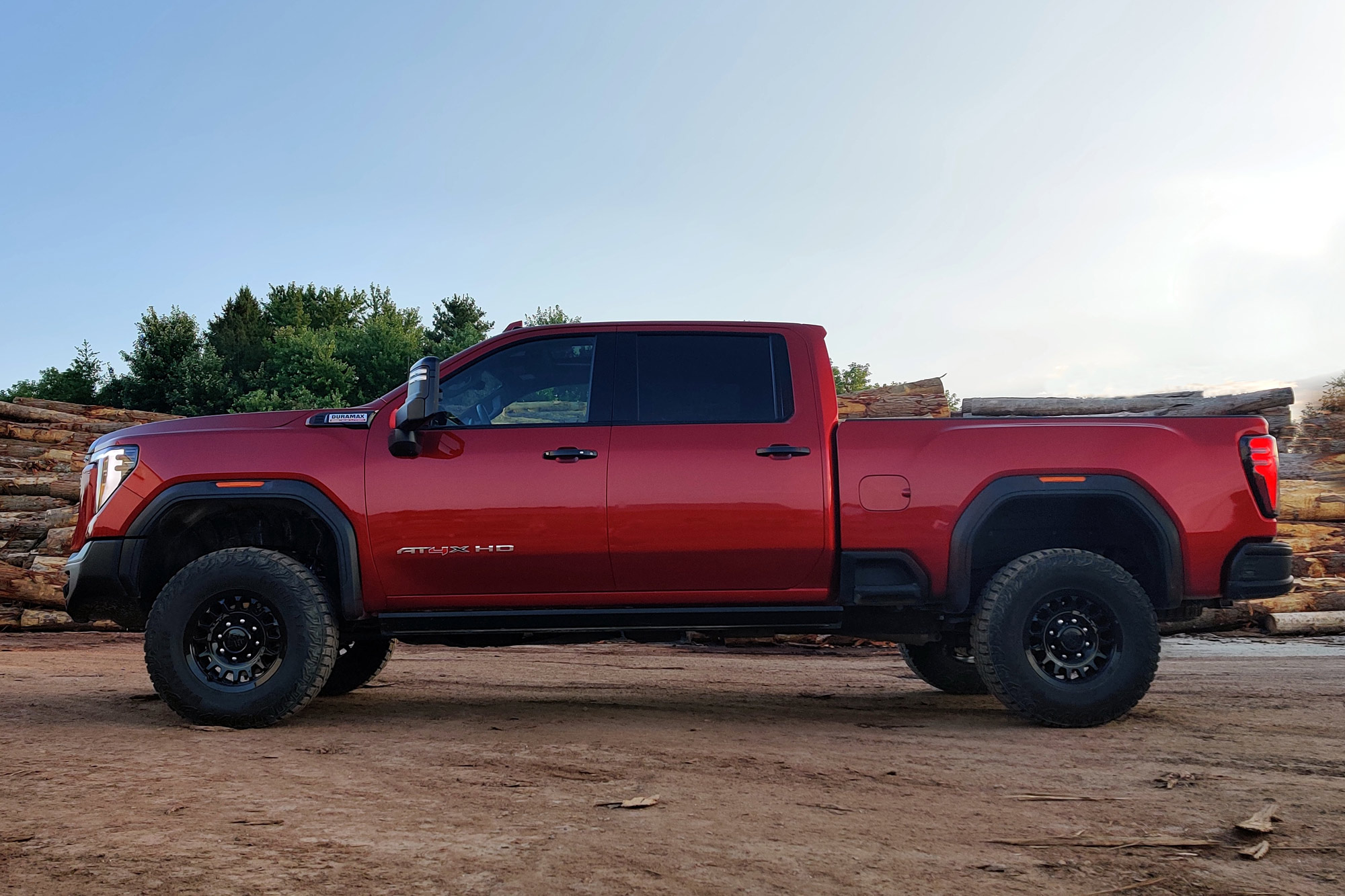 Side of a 2024 GMC Sierra 2500HD AT4X AEV in Volcanic Red