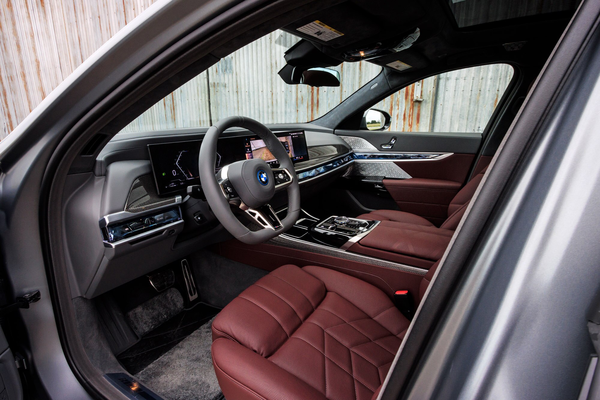 2024 BMW 7 Series interior, dashboard and dark red leather front seats