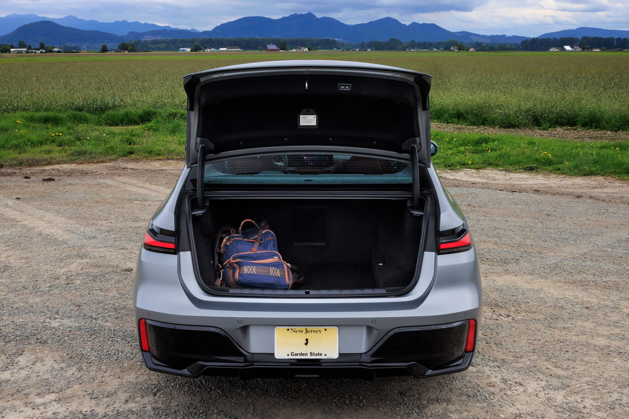 2024 BMW 7 Series trunk and cargo space containing a backpack for scale