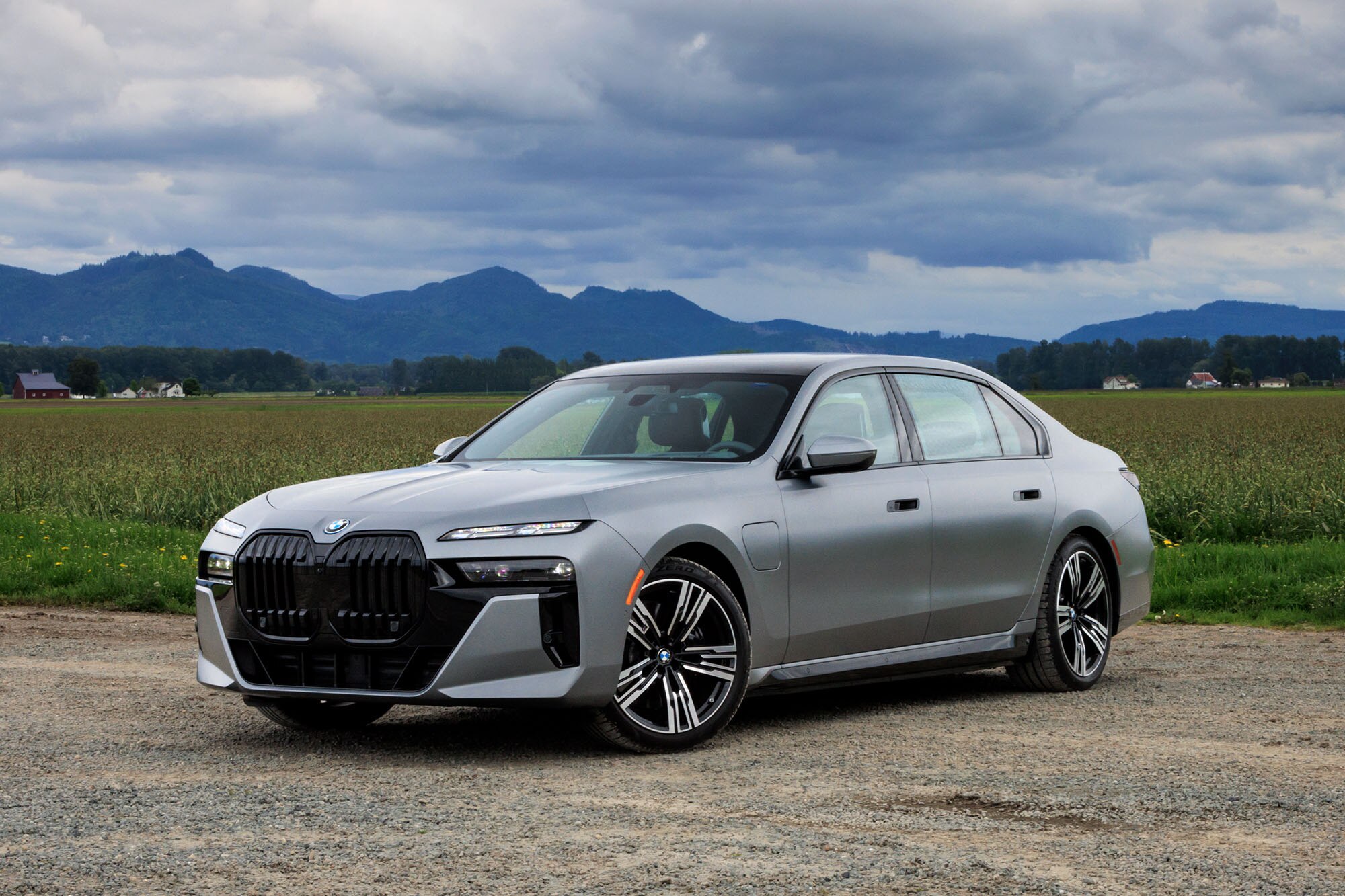 2024 BMW 750e plug-in hybrid in Frozen Pure Grey Metallic with mountains in the background