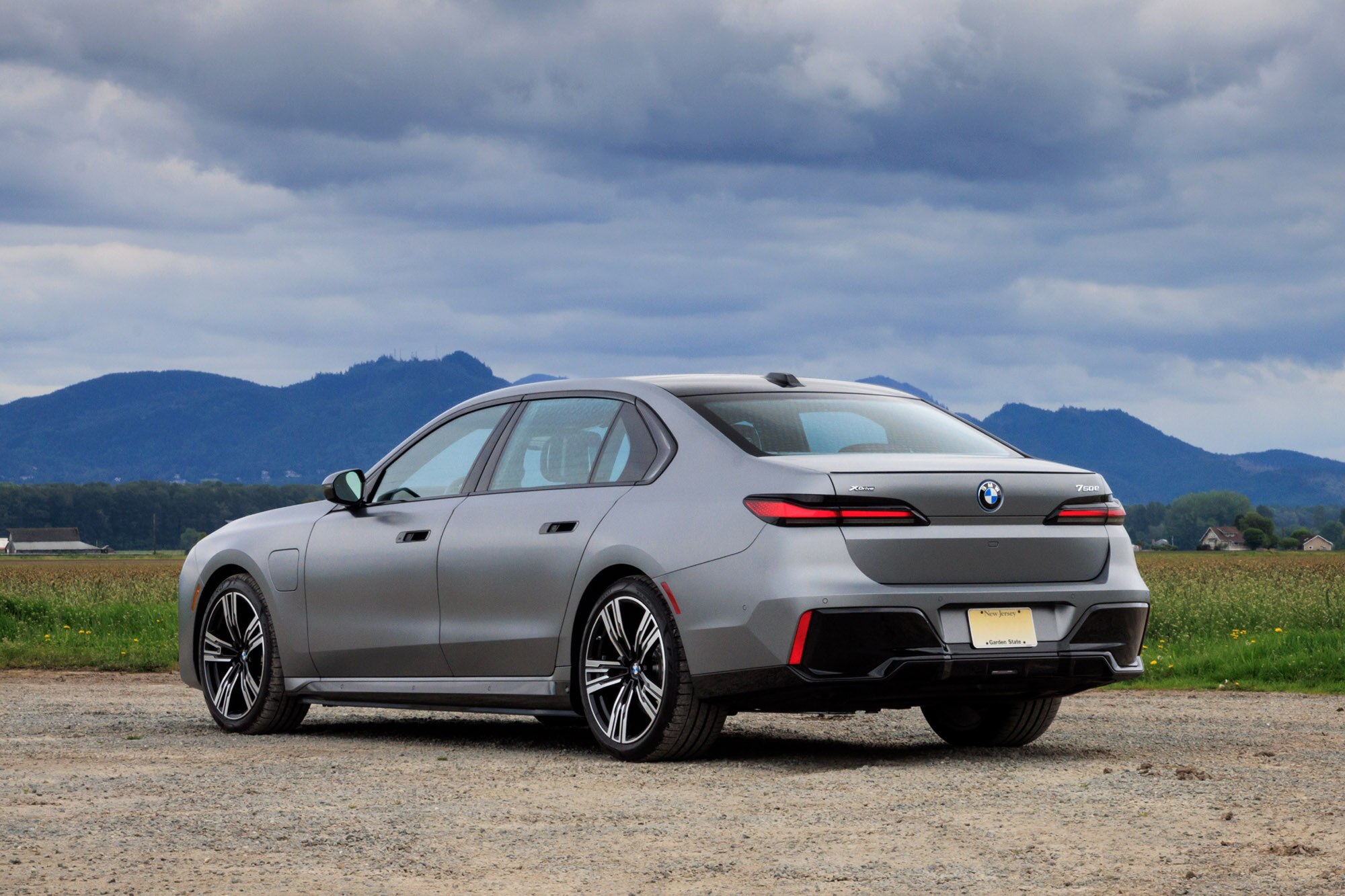 2024 BMW 750e plug-in hybrid in Frozen Pure Grey Metallic with mountains in the background