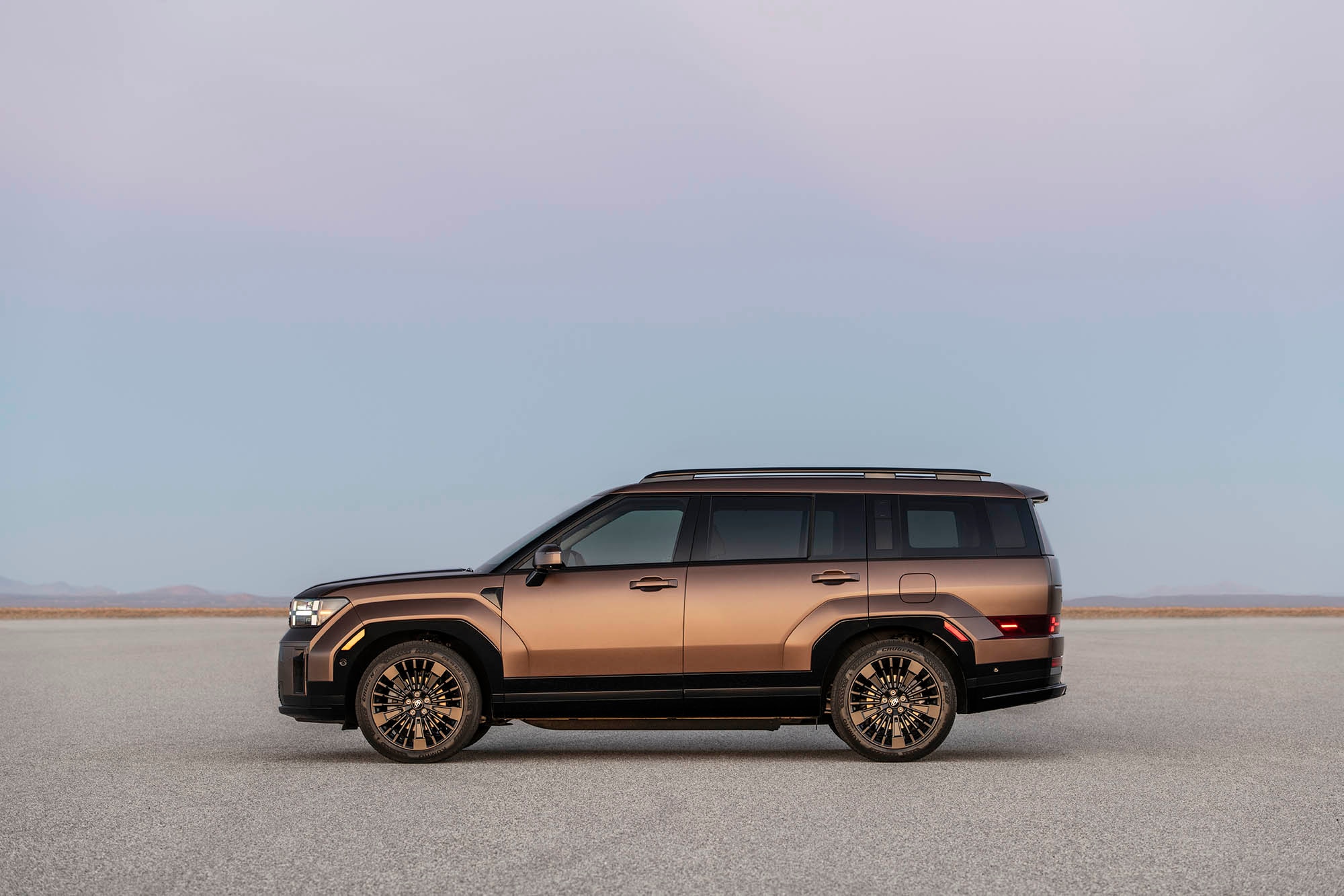 Bronze Hyundai Santa Fe parked in a desert setting.