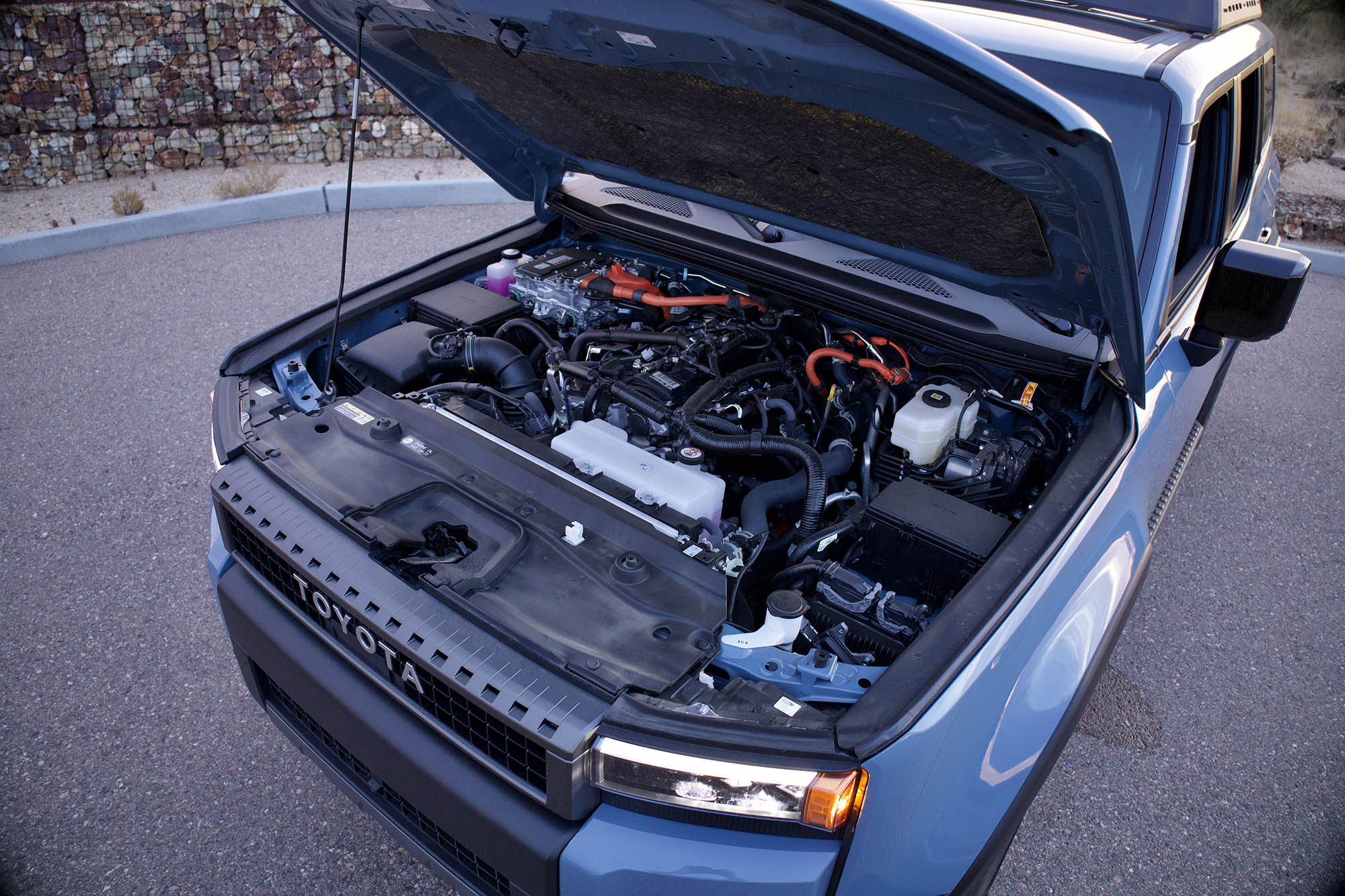 Toyota Land Cruiser with an open hood.