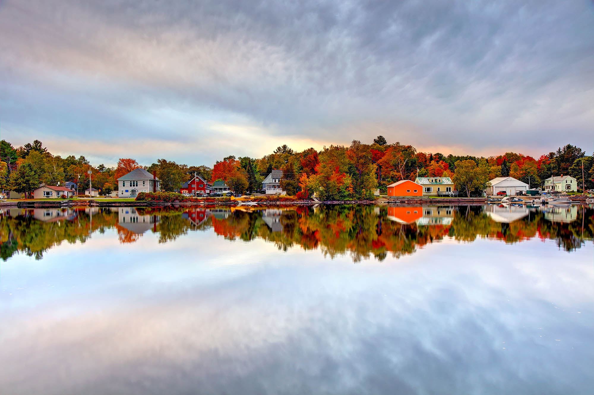 Houses reflected in Moosehead Lake in Maine.