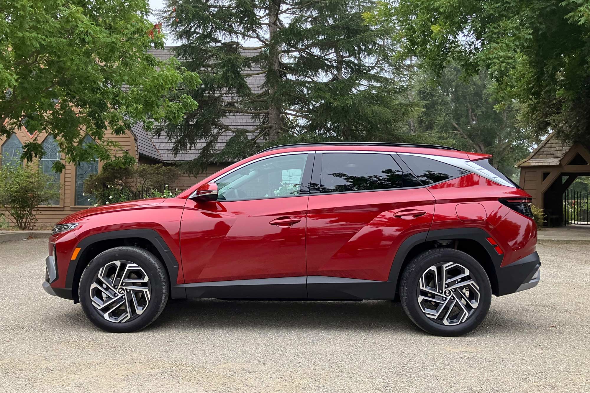 Side of a 2025 Hyundai Tucson Hybrid Limited in Ultimate Red