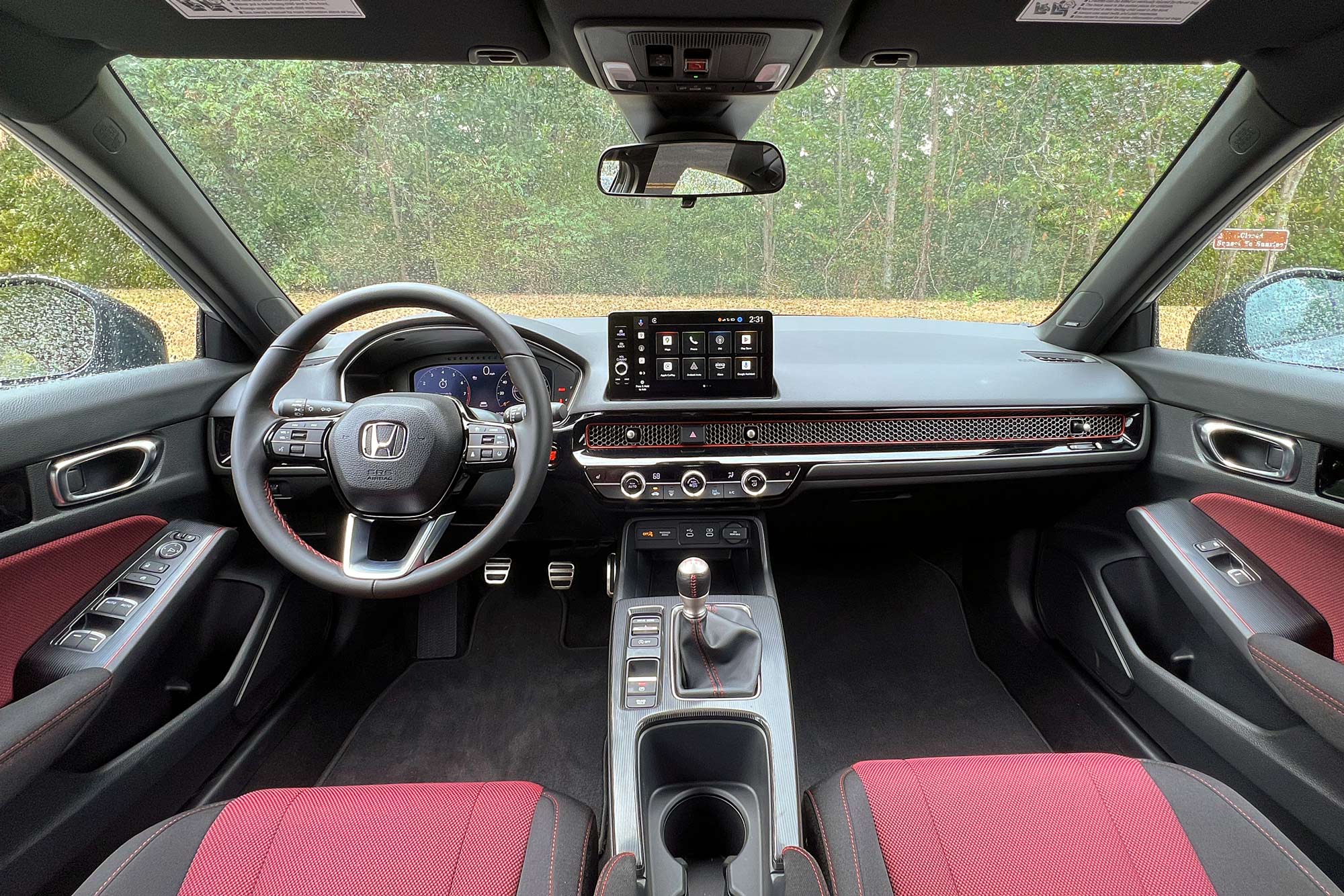 2025 Honda Civic Si interior showing the dashboard and front seats.