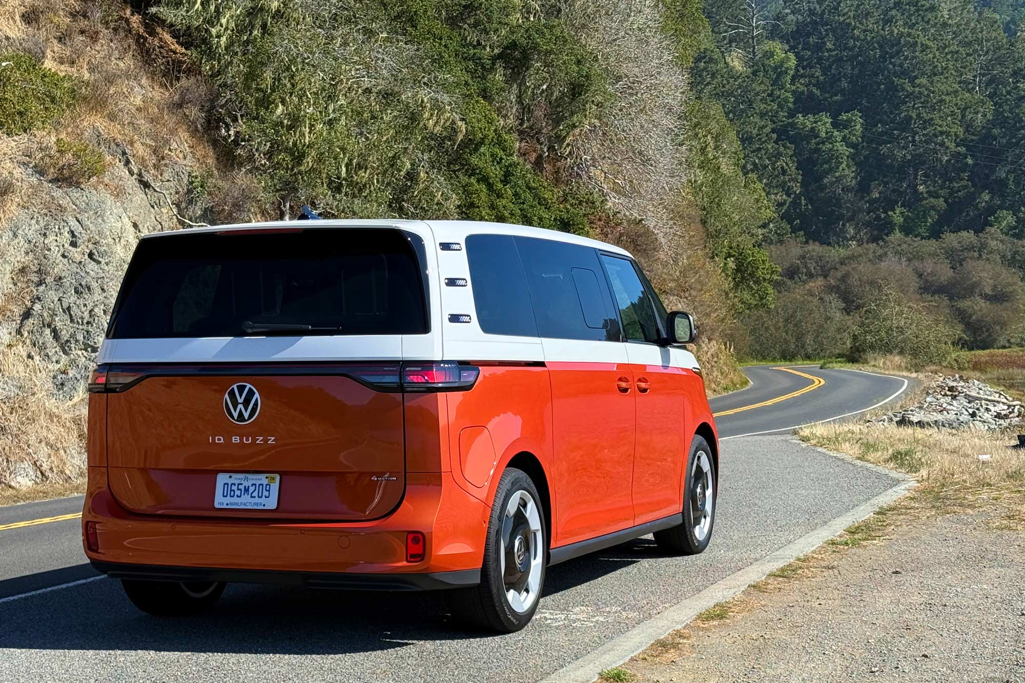 2025 Volkswagen ID. Buzz parked by a winding road.