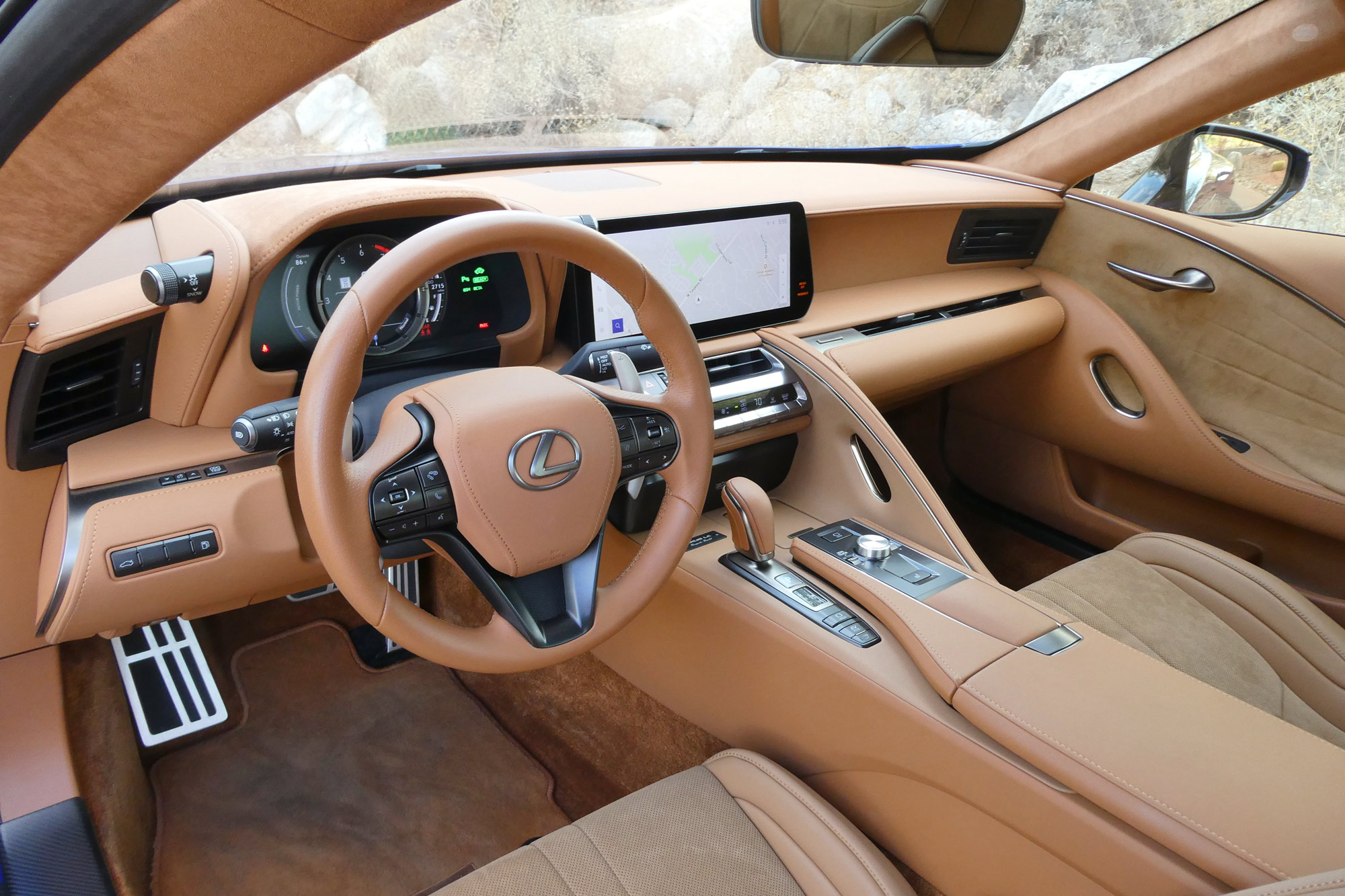 Caramel-colored 2024 Lexus LC 500h interior showing the dashboard and front seats