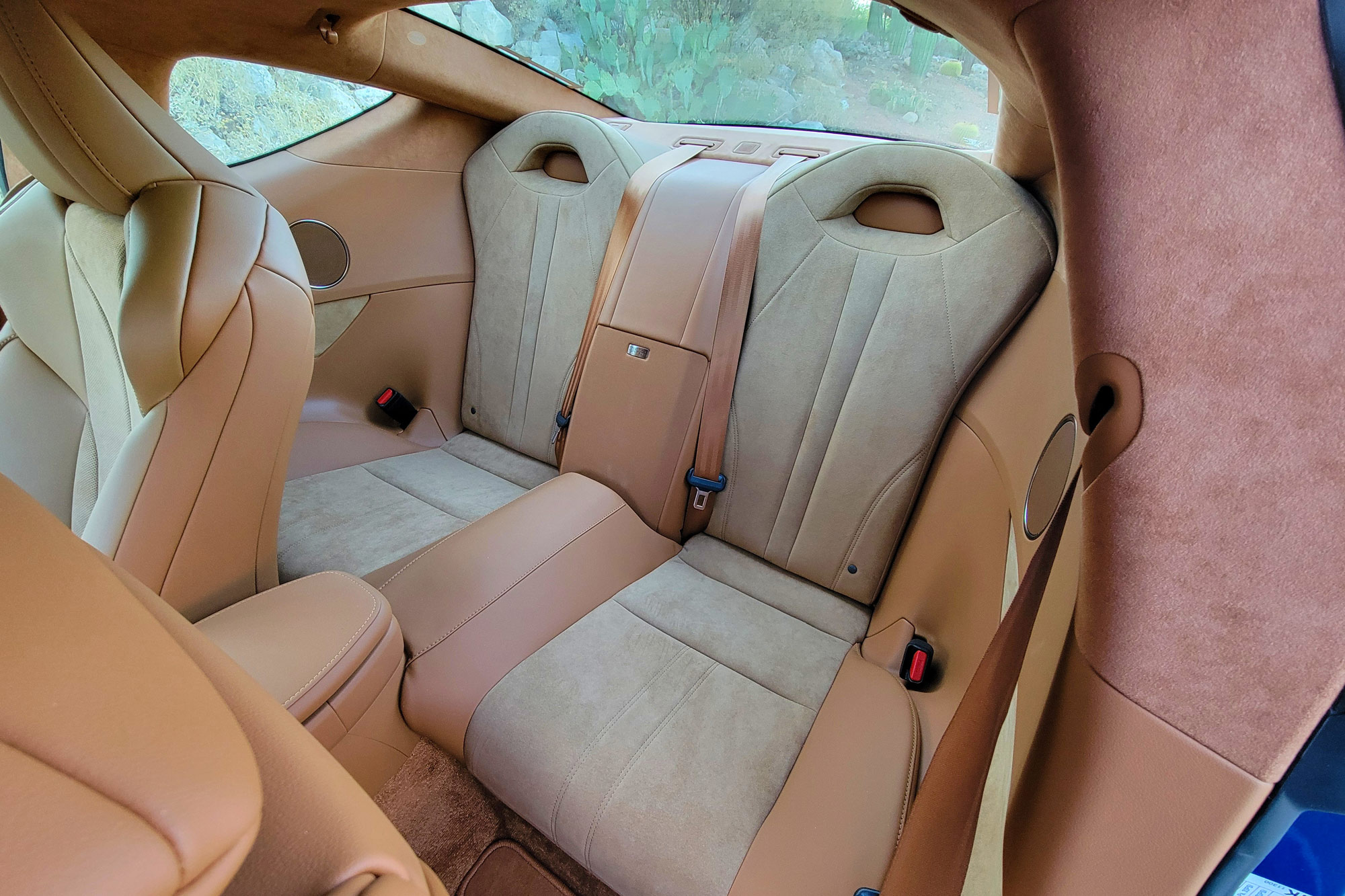 Caramel-colored 2024 Lexus LC 500h interior showing the back seats