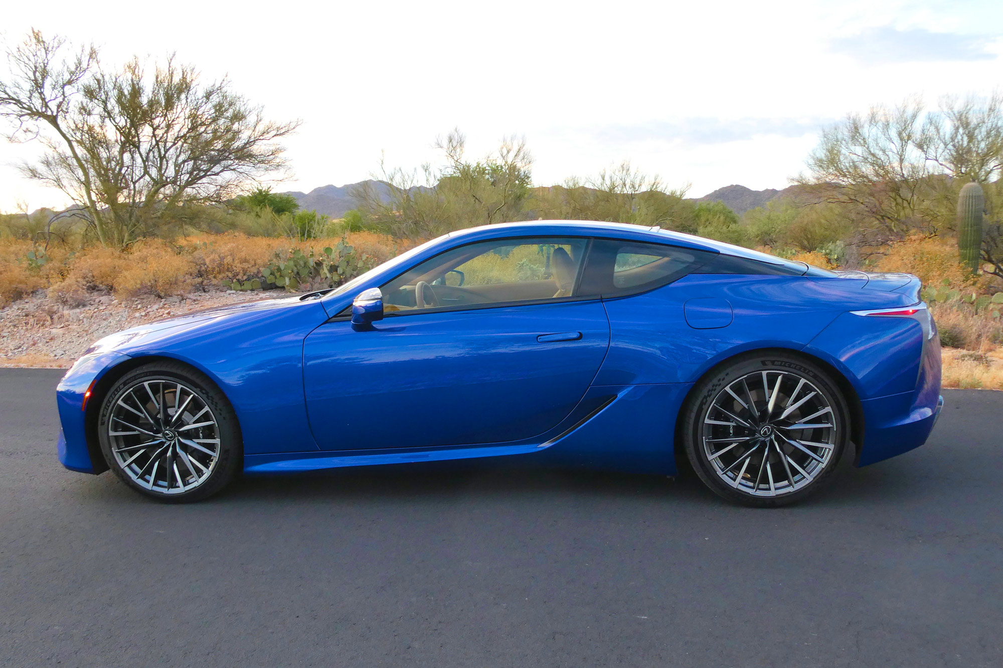 Rear-quarter of a blue 2024 Lexus LC 500h parked in a neighborhood