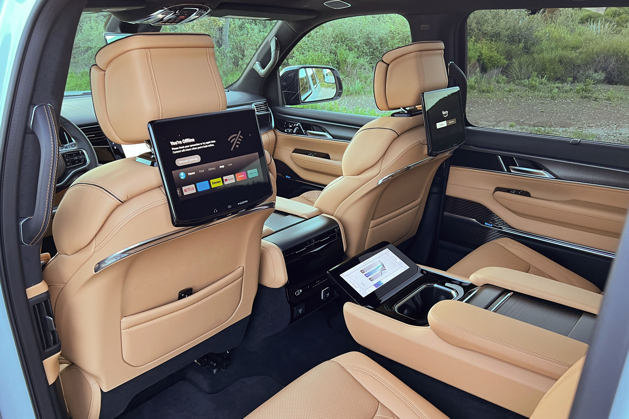 Tupelo Tan 2024 Jeep Grand Wagoneer L Series III Obsidian interior showing the available rear-seat entertainment system