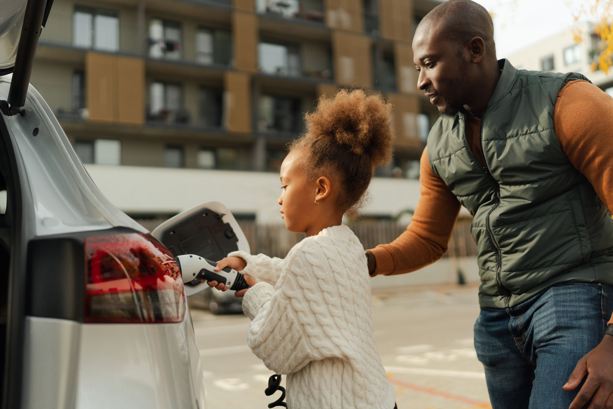 Parent and child charging vehicle in parking lot