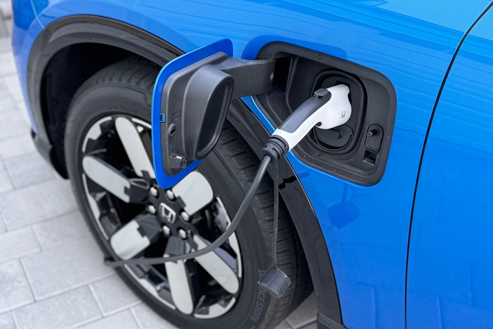 2024 Honda Prologue Elite in Pacific Blue plugged in and charging.