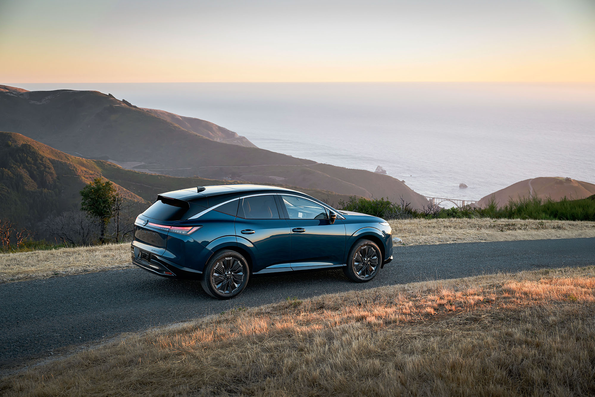 2025 Nissan Murano in blue parked above the Bixby Bridge in Big Sur