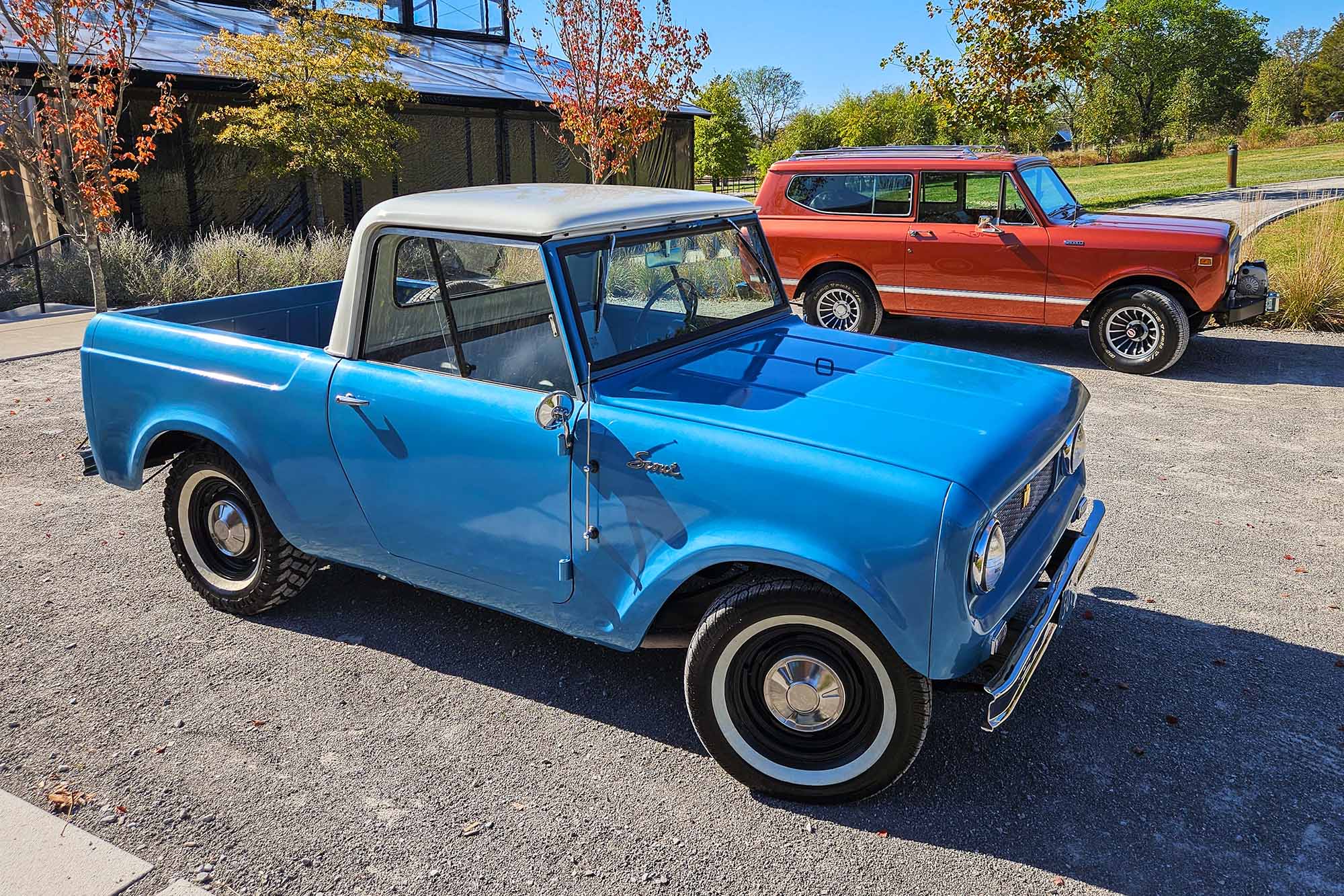 Original International Harvester Scout pickup truck in blue and Scout SUV in orange