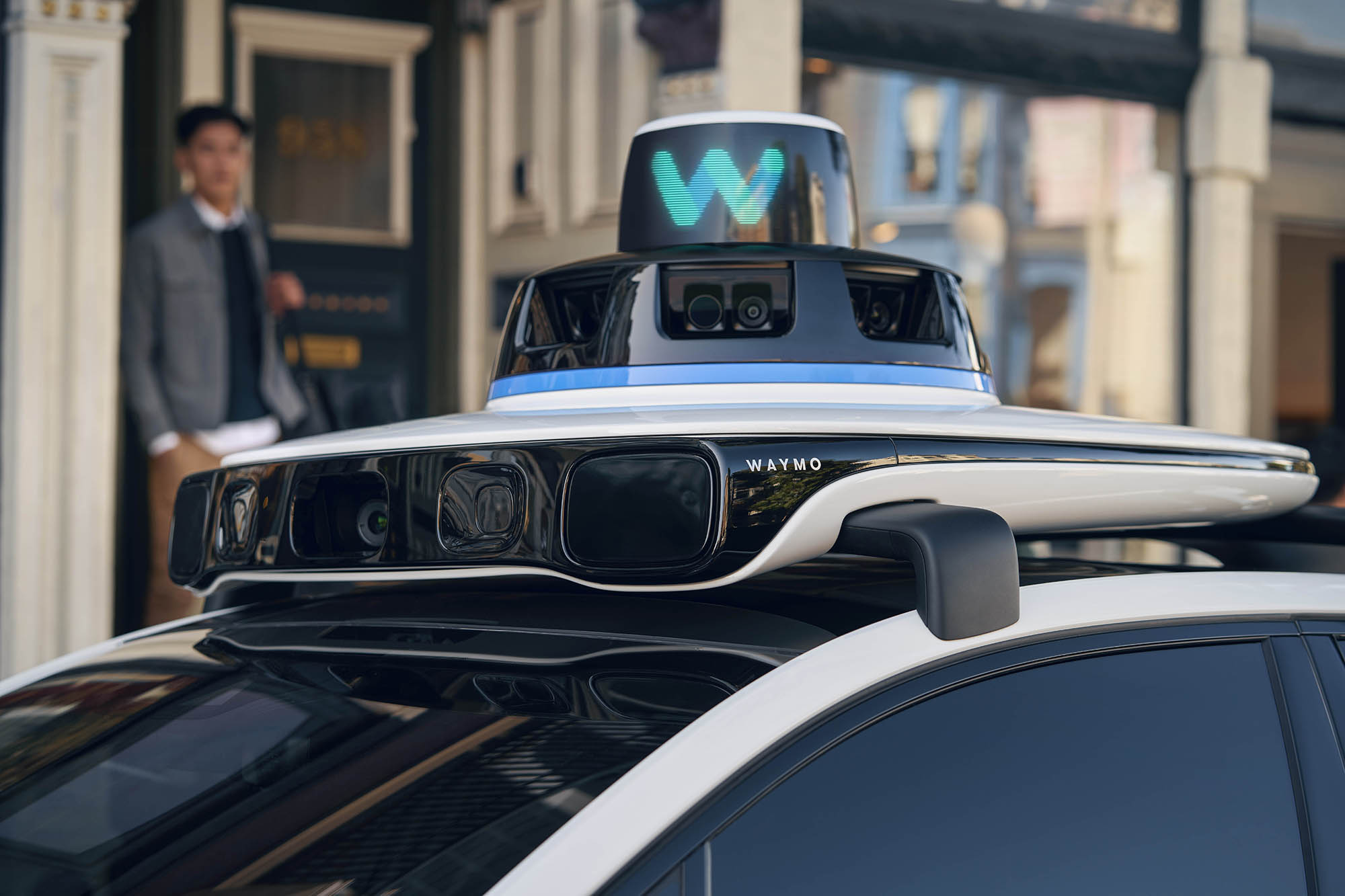 A bank of sensors on top of a Waymo taxi