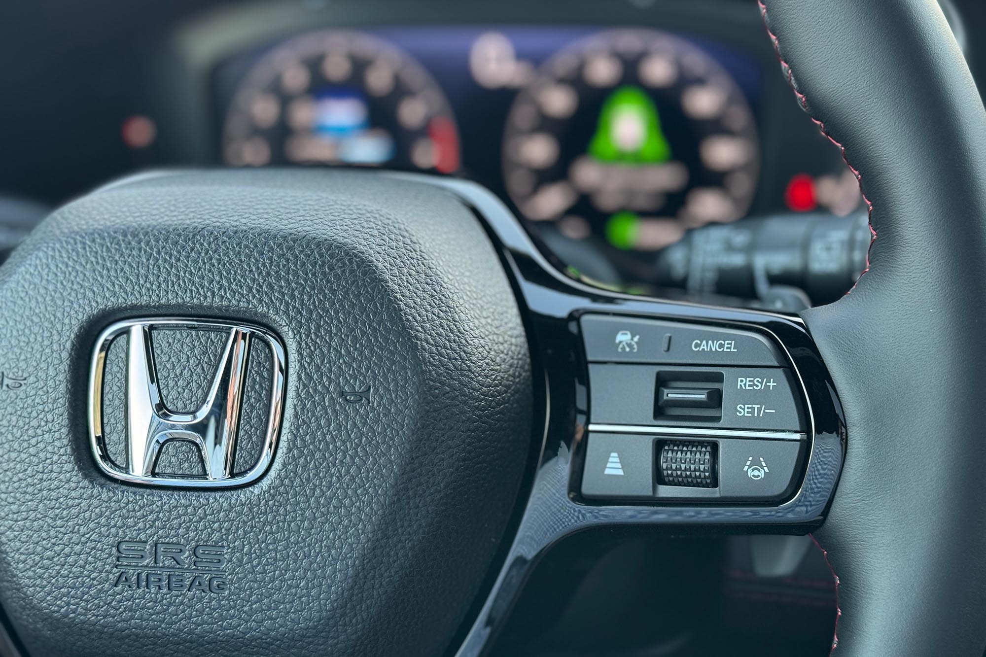 2025 Honda Pilot Black Edition interior showing the safety feature controls on the steering wheel.