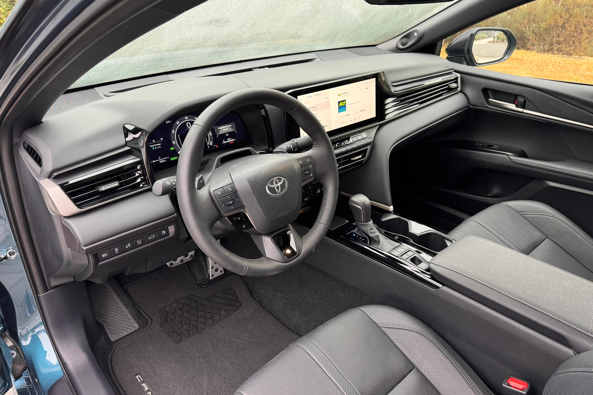 2025 Toyota Camry XSE interior showing the dashboard and front seats.