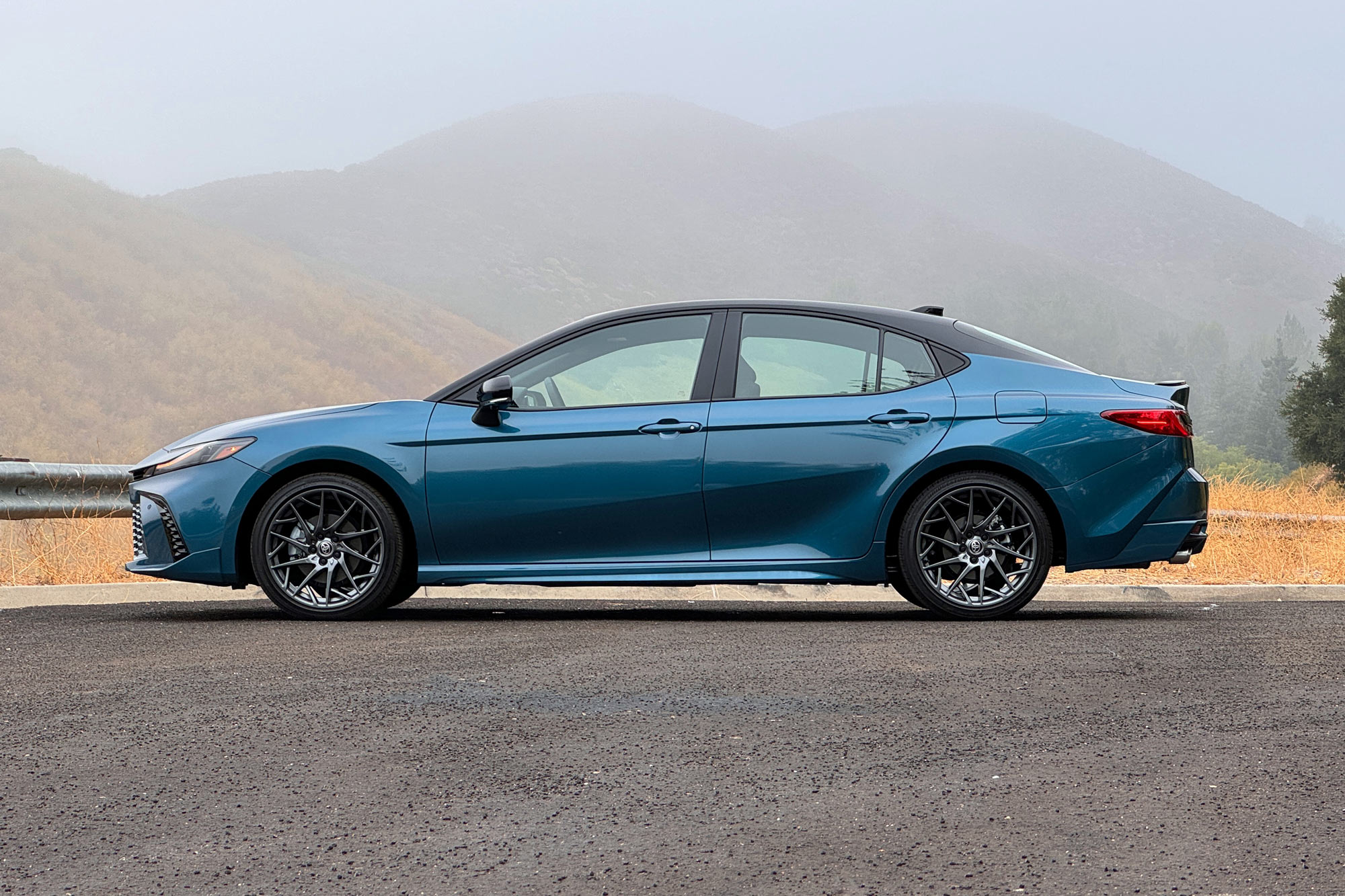 2025 Toyota Camry XSE in Ocean Gem with dry brush and foggy mountains in the background.