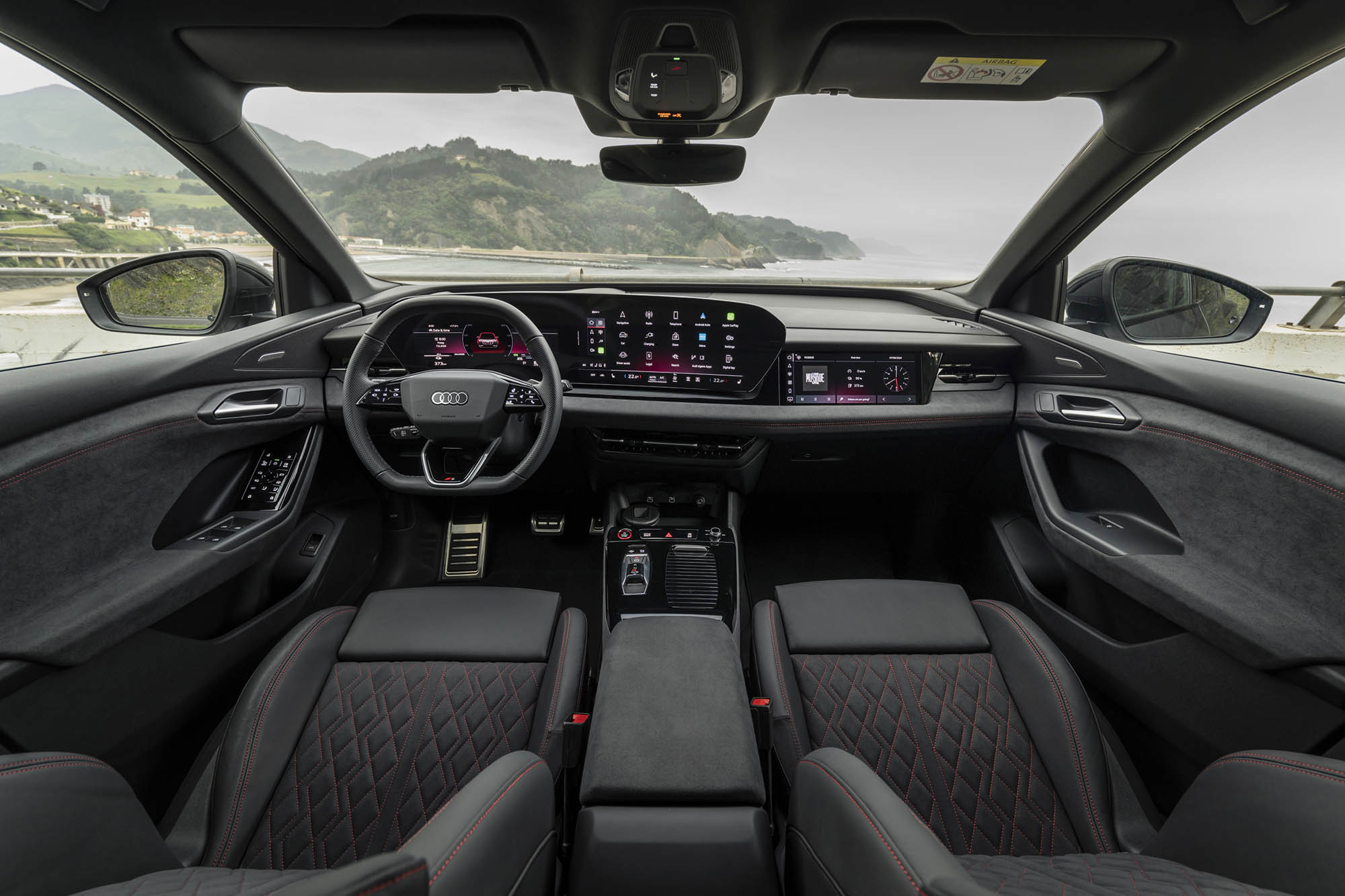 The front seats and dashboard of a 2025 Audi Q6 e-tron.