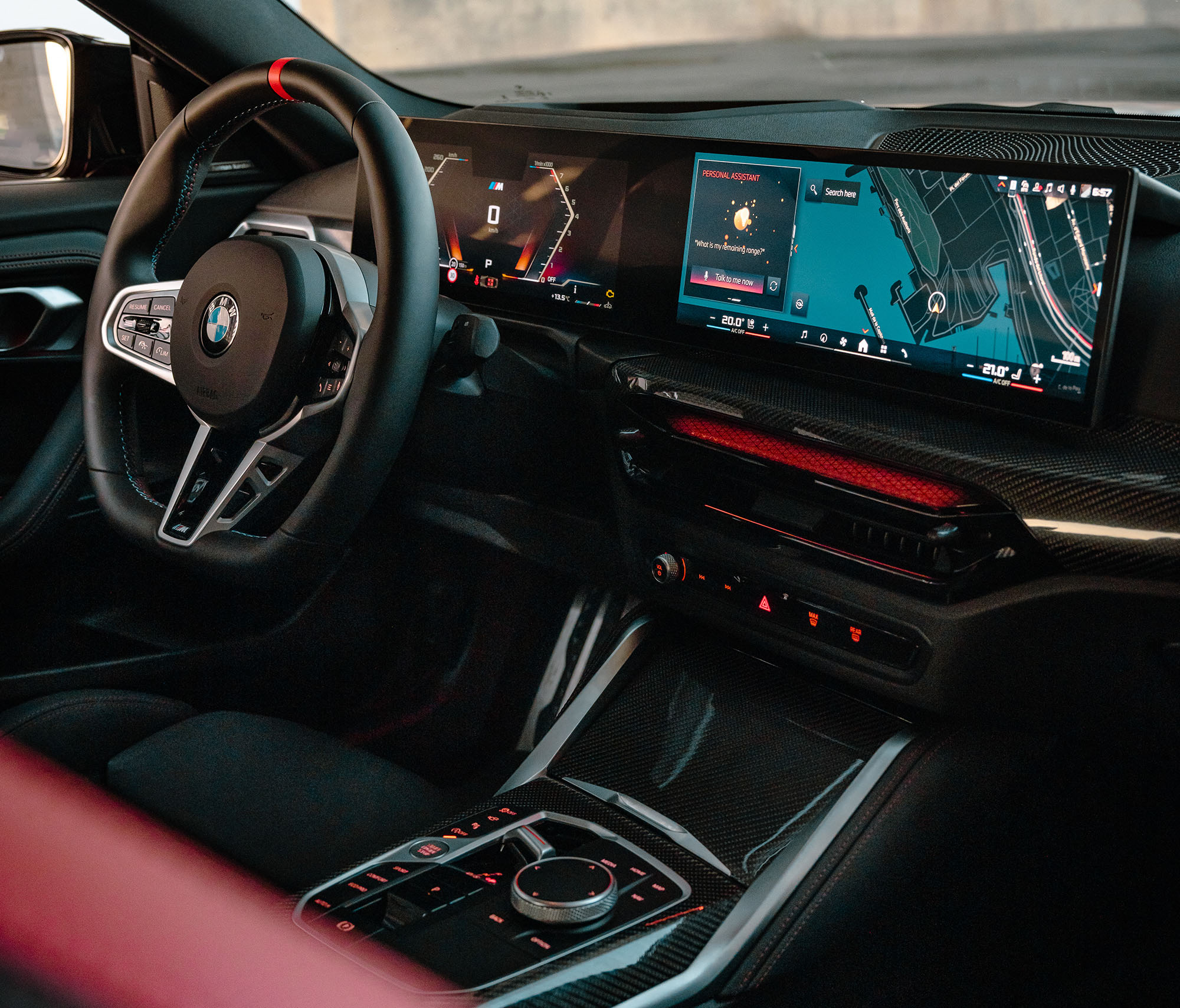 2025 BMW M240i xDrive interior showing the BMW Curved Display, center console, and steering wheel