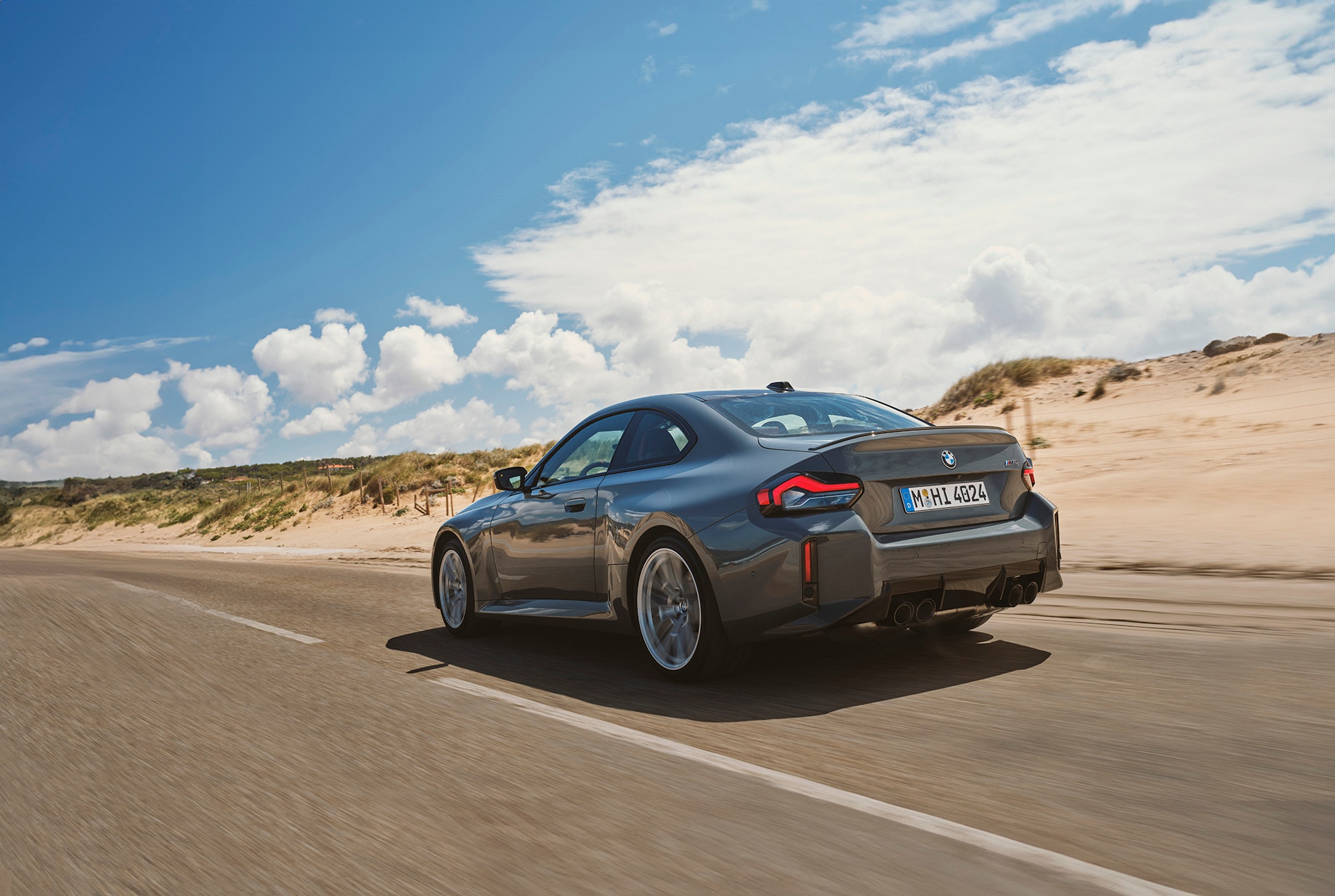 2025 BMW M2 in gray, driving, rear view