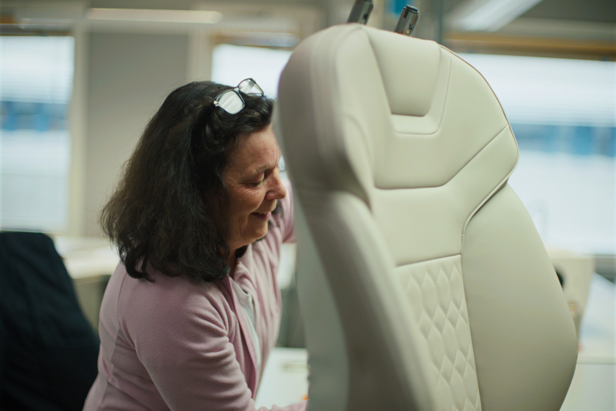 Person works on a Volvo vehicle seat with sustainably produced upholstery