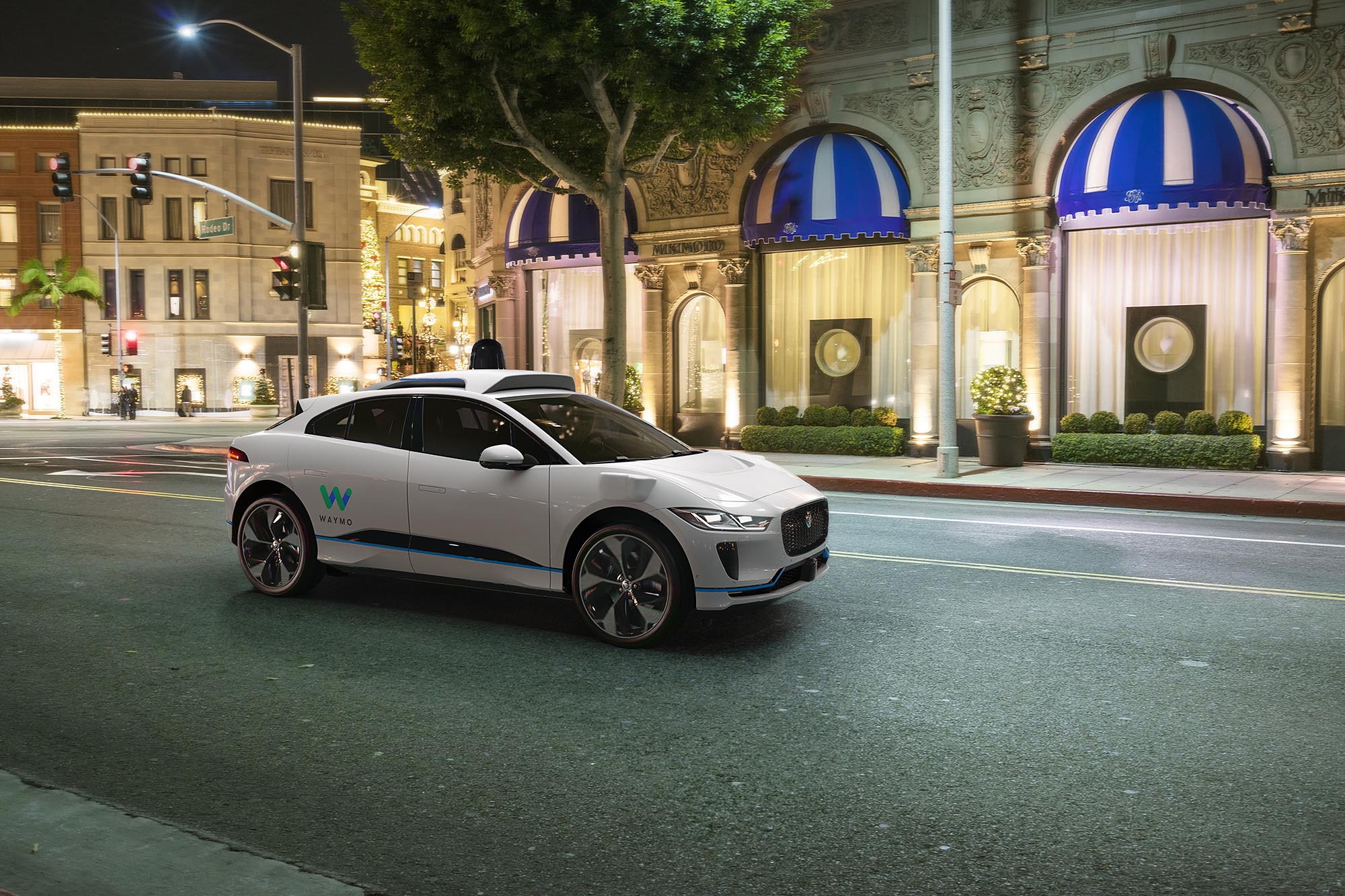 White Jaguar I-Pace being used as a Waymo One robo-taxi navigates on Rodeo Drive in Beverly Hills, California