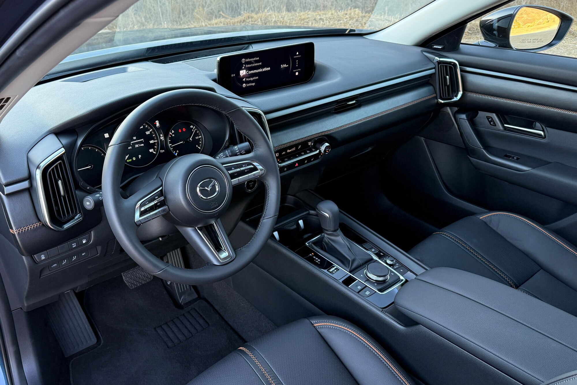 Steering wheel and dashboard in a 2025 Mazda CX-50 Hybrid Premium Plus