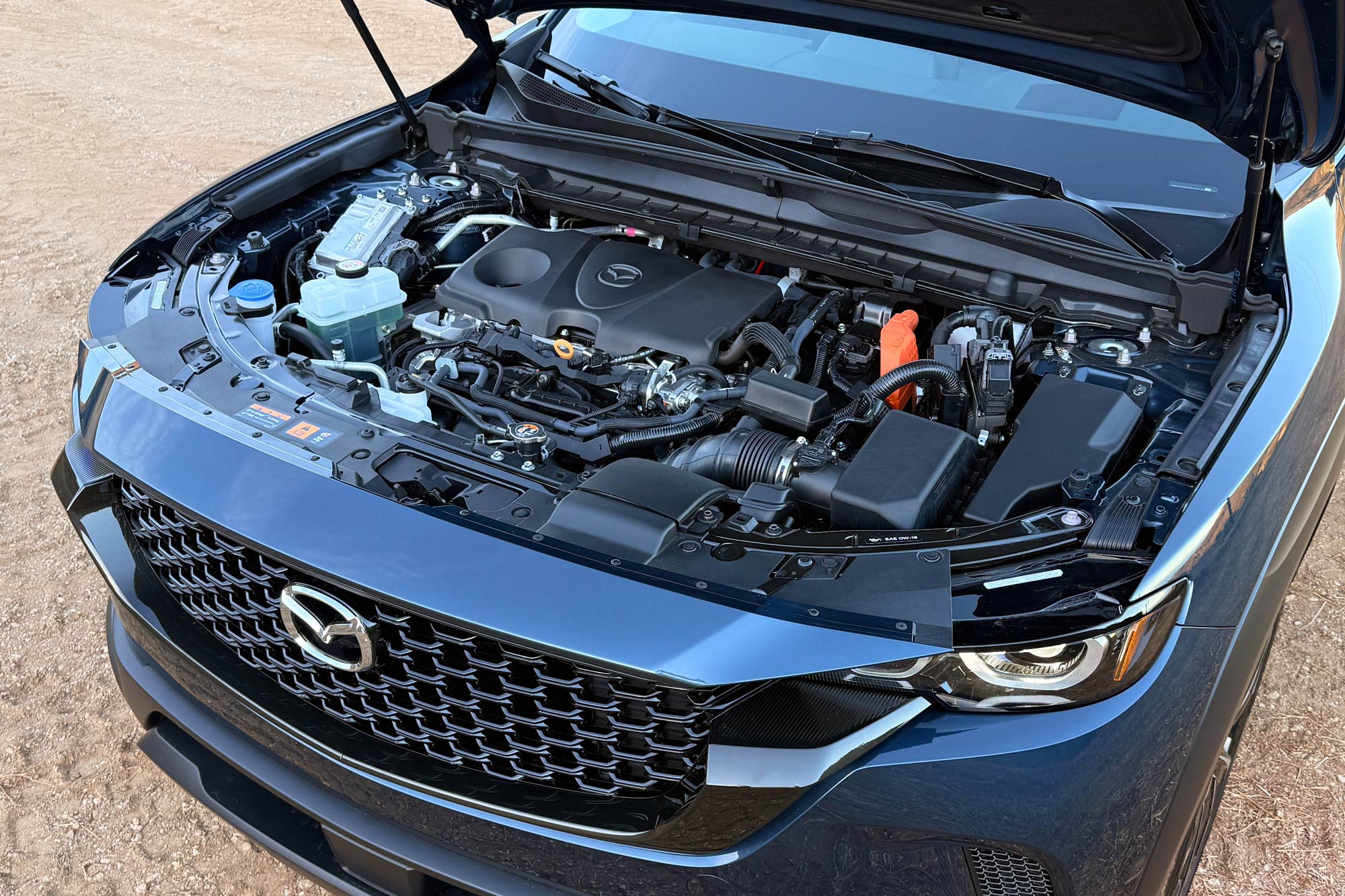 2025 Mazda CX-50 Hybrid Premium Plus showing the 2.5-liter gasoline engine under the hood.