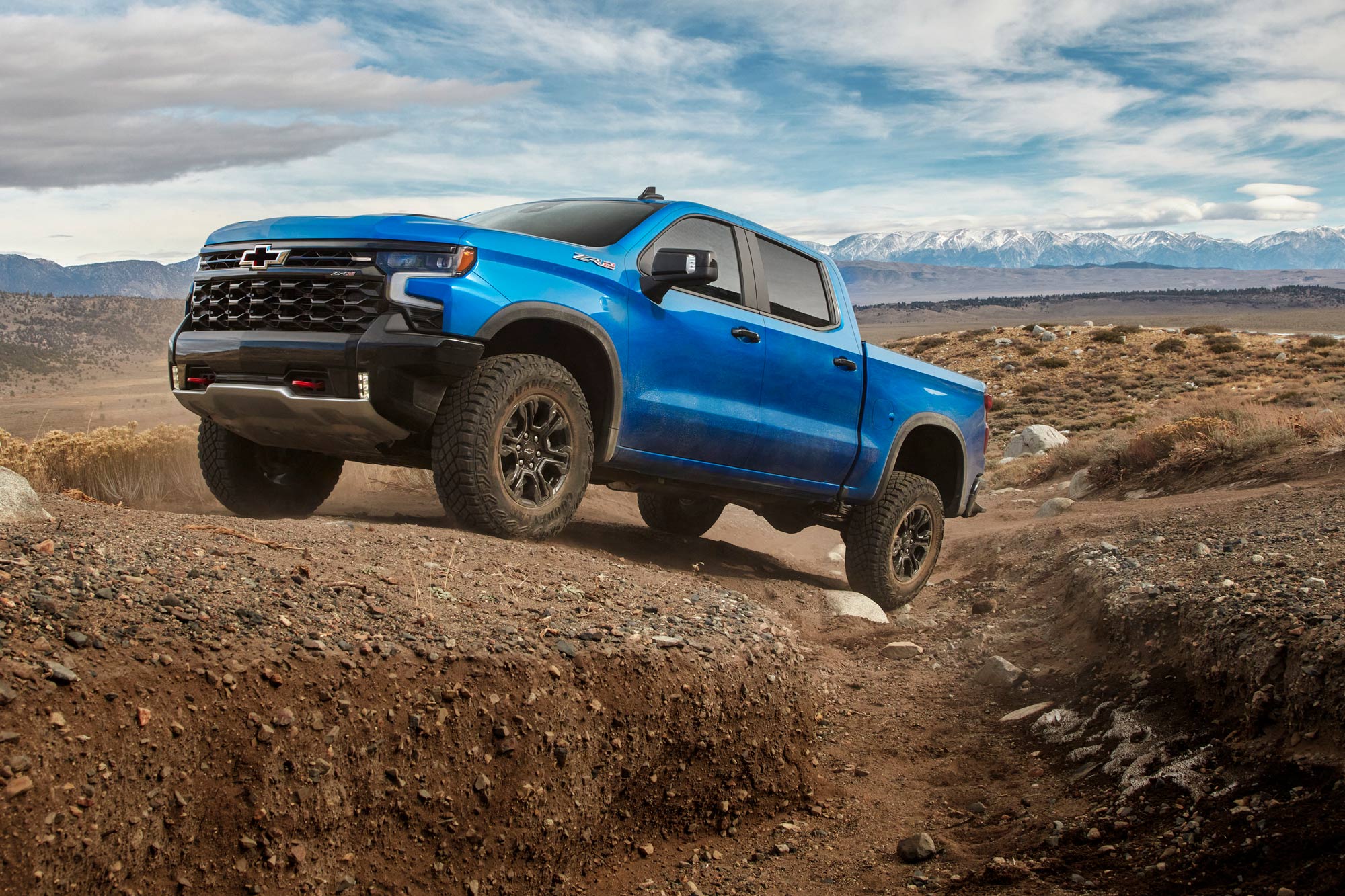 A blue 2024 Chevrolet Silverado ZR2 navigates off-road