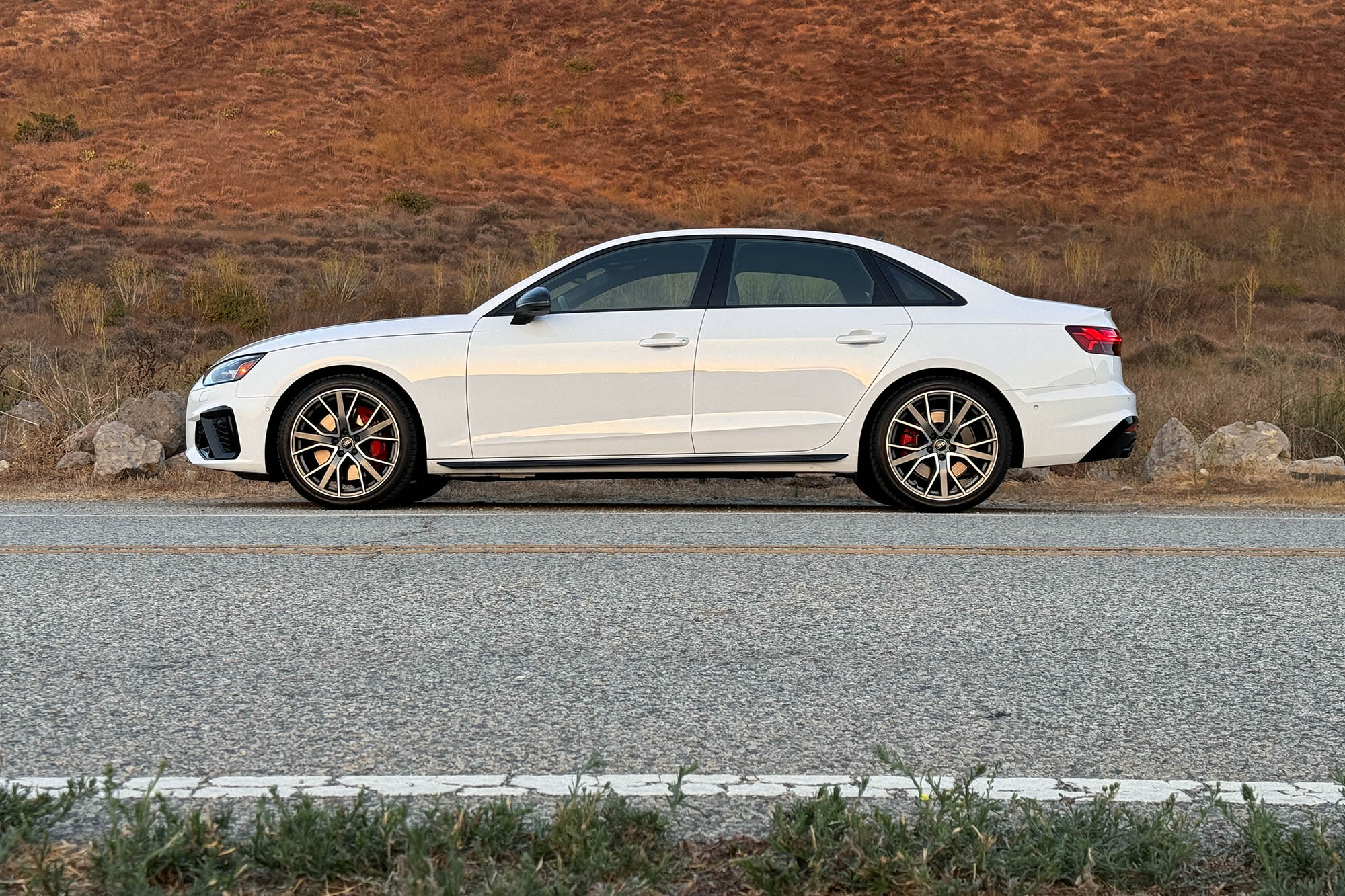 2025 Audi S4 in Arkona White, side view with a mountain in the background