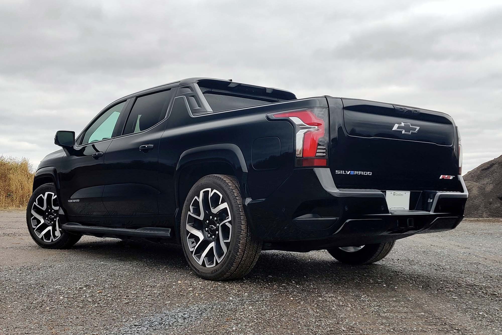 2024 Chevrolet Silverado EV First Edition RST in Black with gray sky in the background.