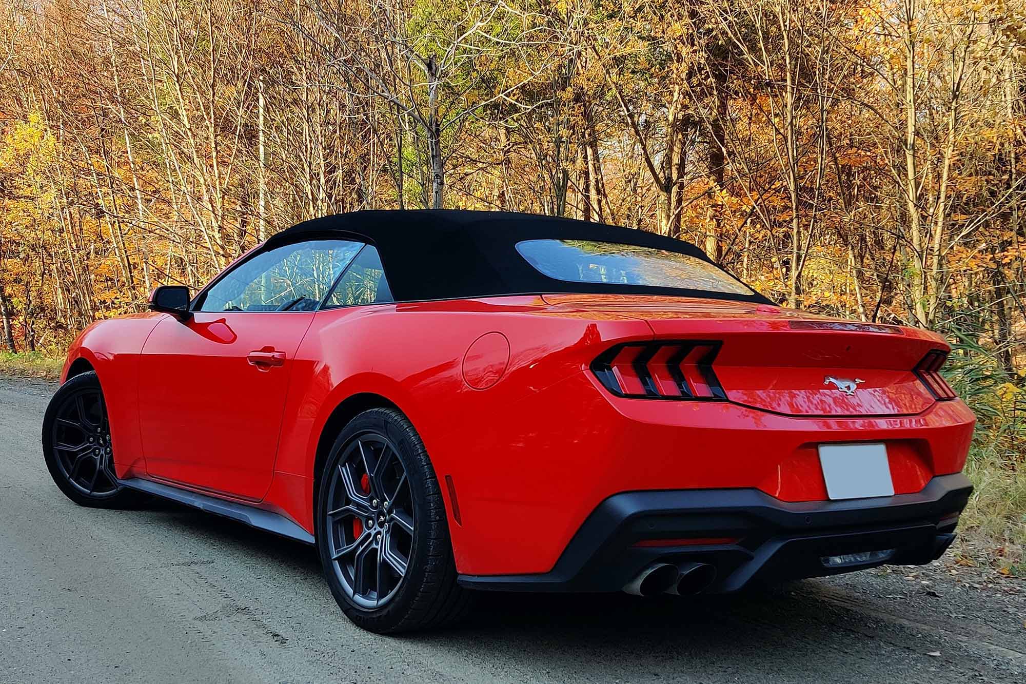 A rear view of a 2024 Ford Mustang Convertible with the top up.