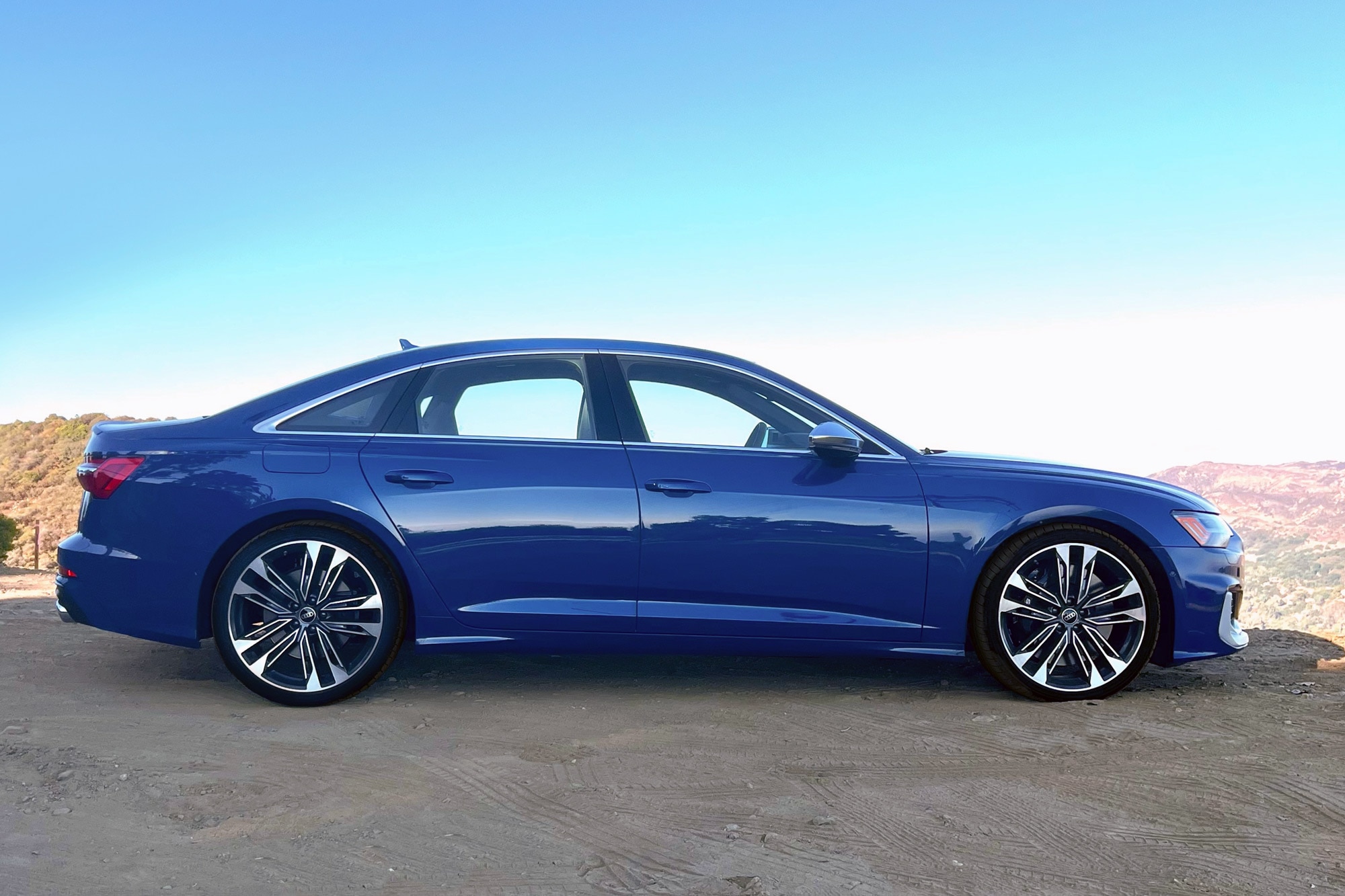 2025 Audi S6 in Ascari Blue with mountains and blue sky in the background