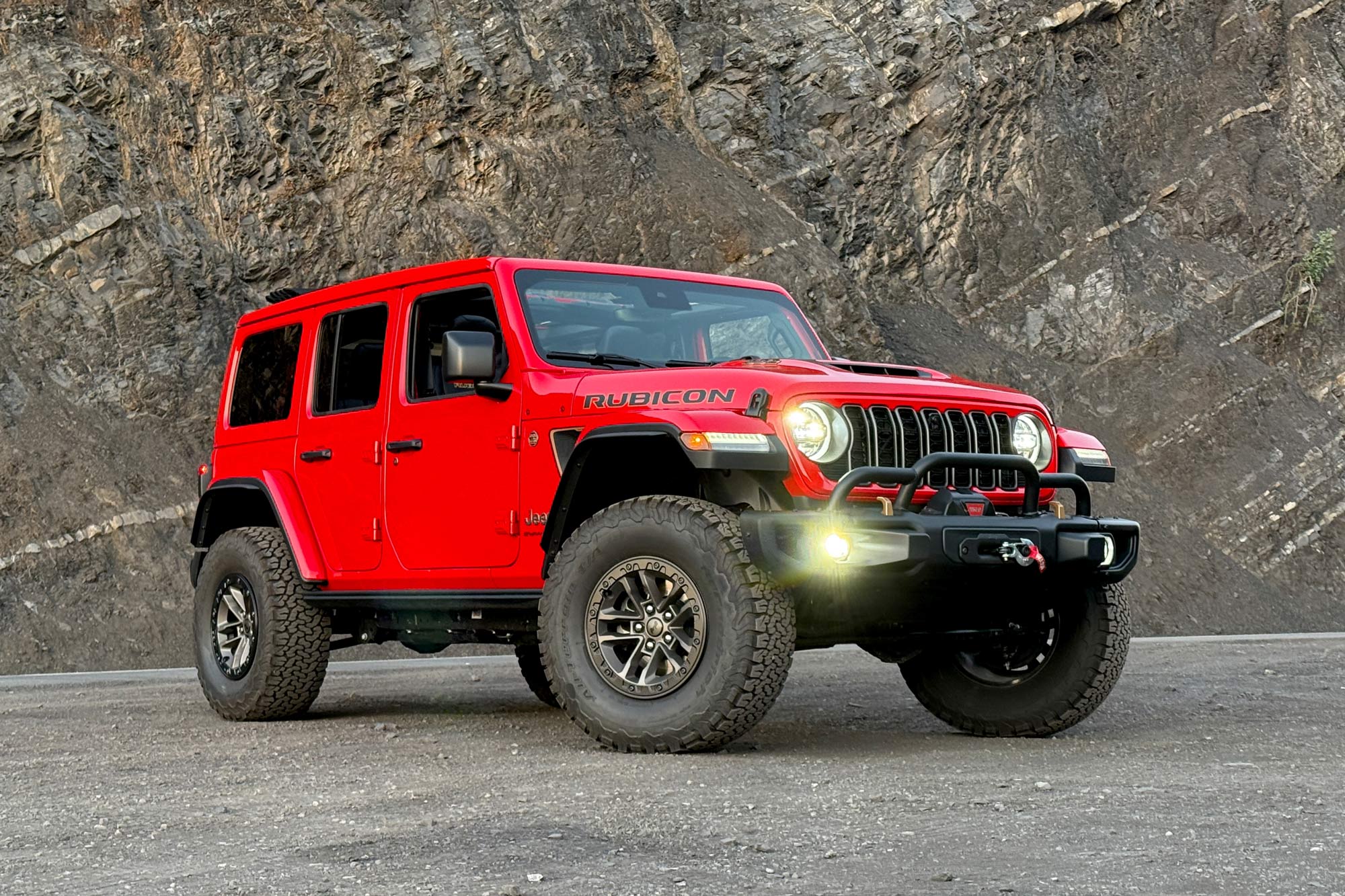 2024 Jeep Wrangler 392 Final Edition in Firecracker Red with a rock wall in the background