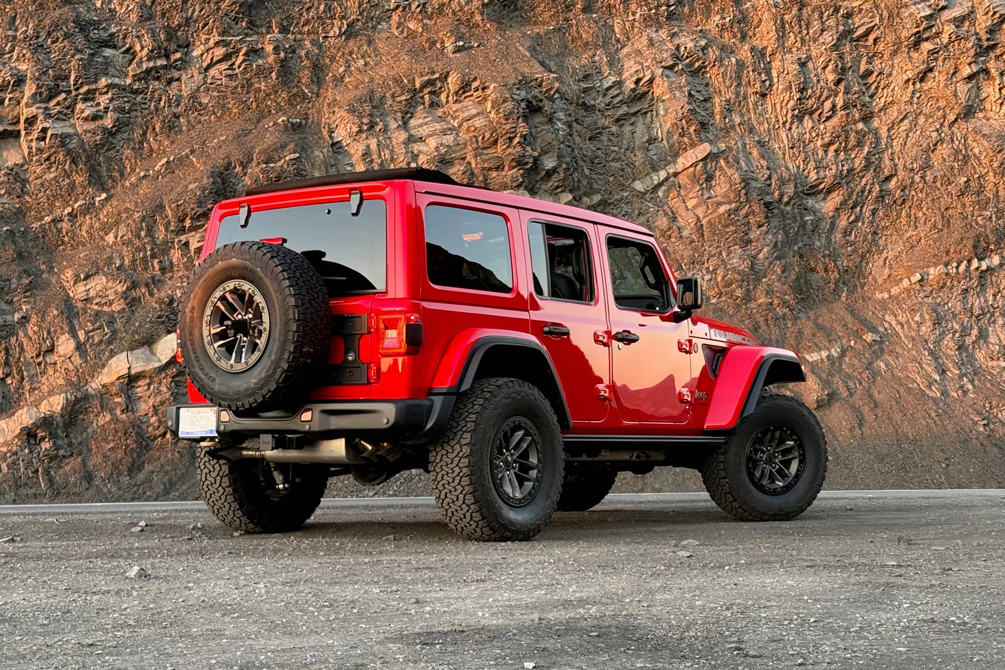  2024 Jeep Wrangler 392 Final Edition in Firecracker Red with a rock wall in the background