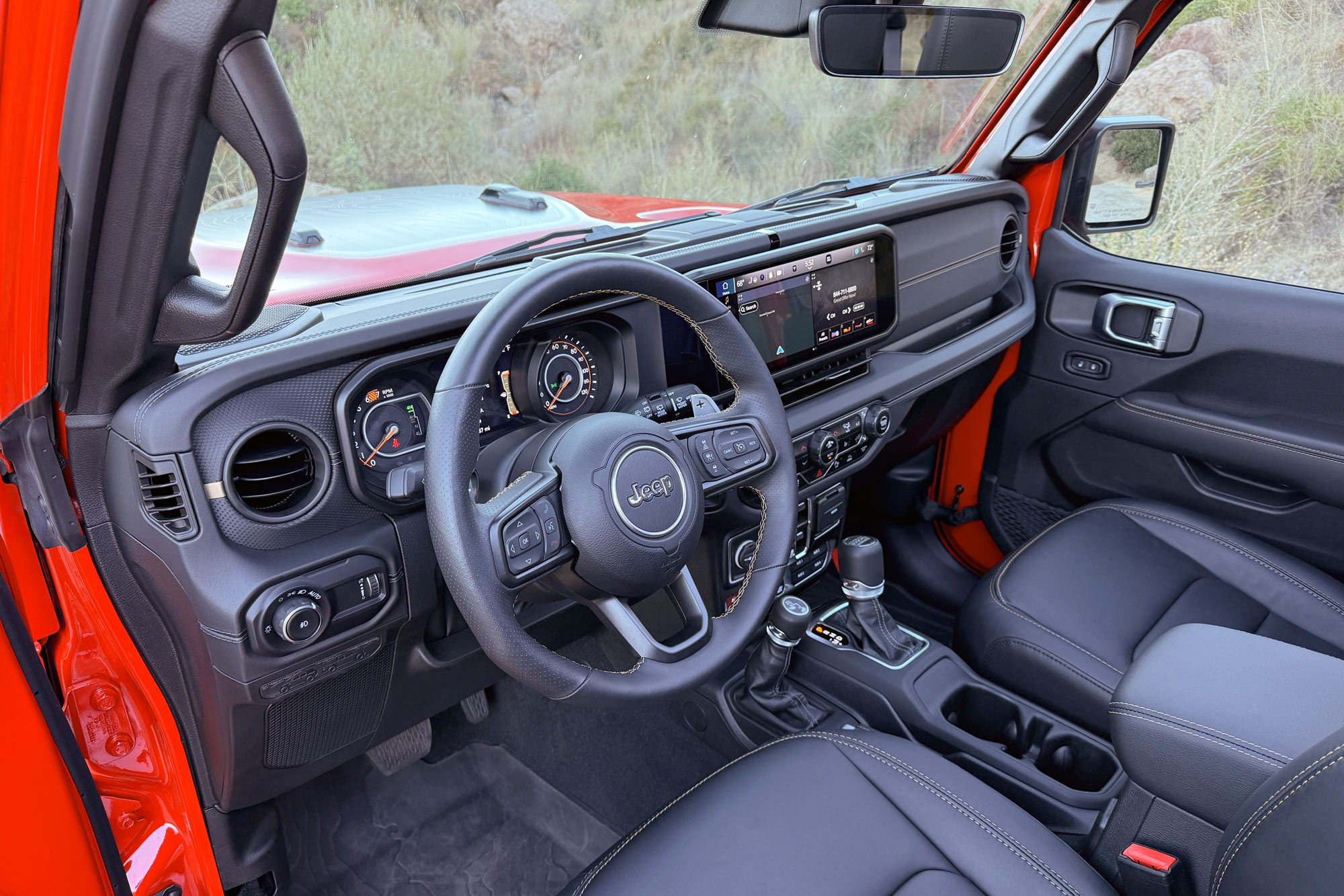 Red 2024 Jeep Wrangler 392 Final Edition interior showing the dashboard and front seats