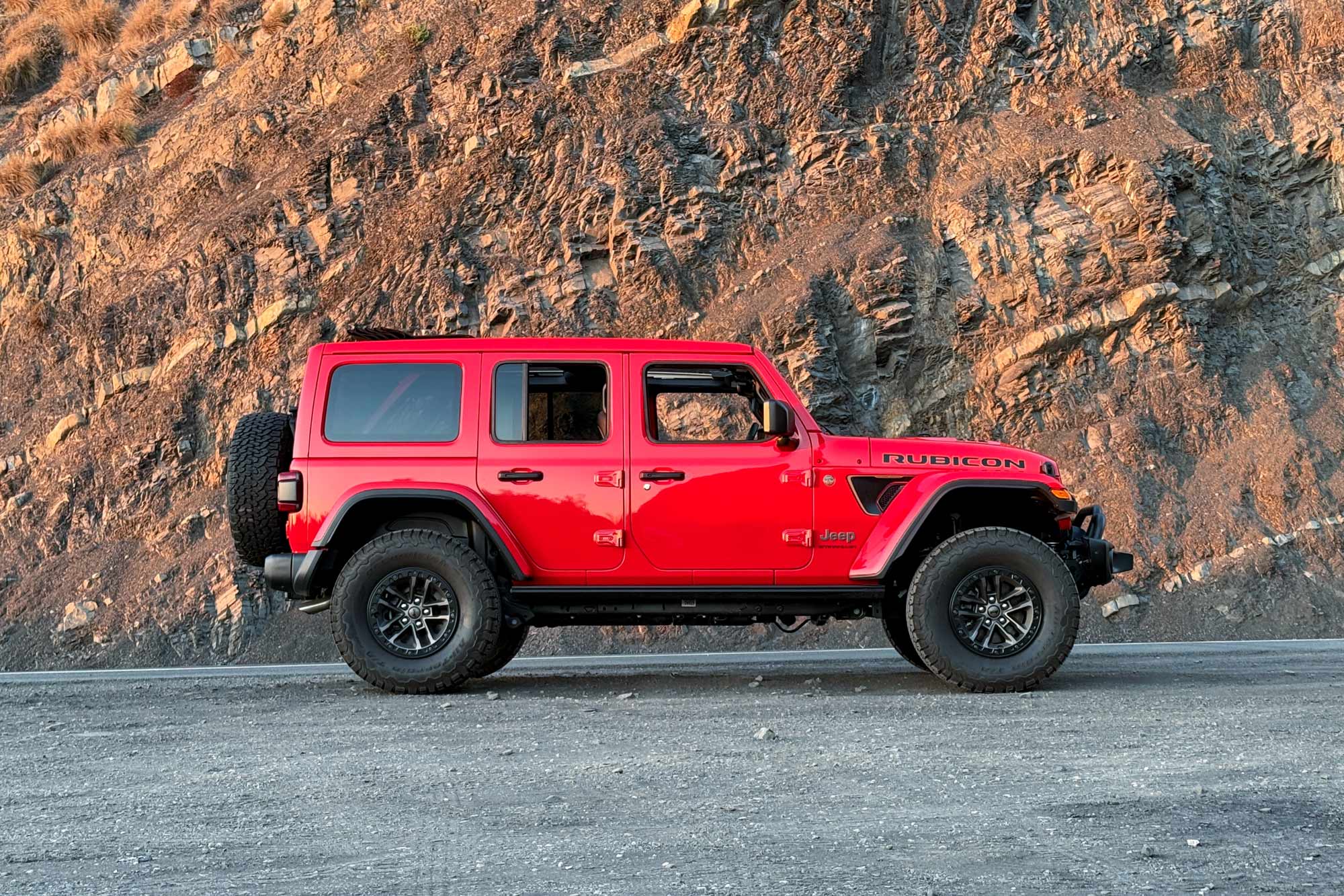 2024 Jeep Wrangler 392 Final Edition in Firecracker Red with a rock wall in the background