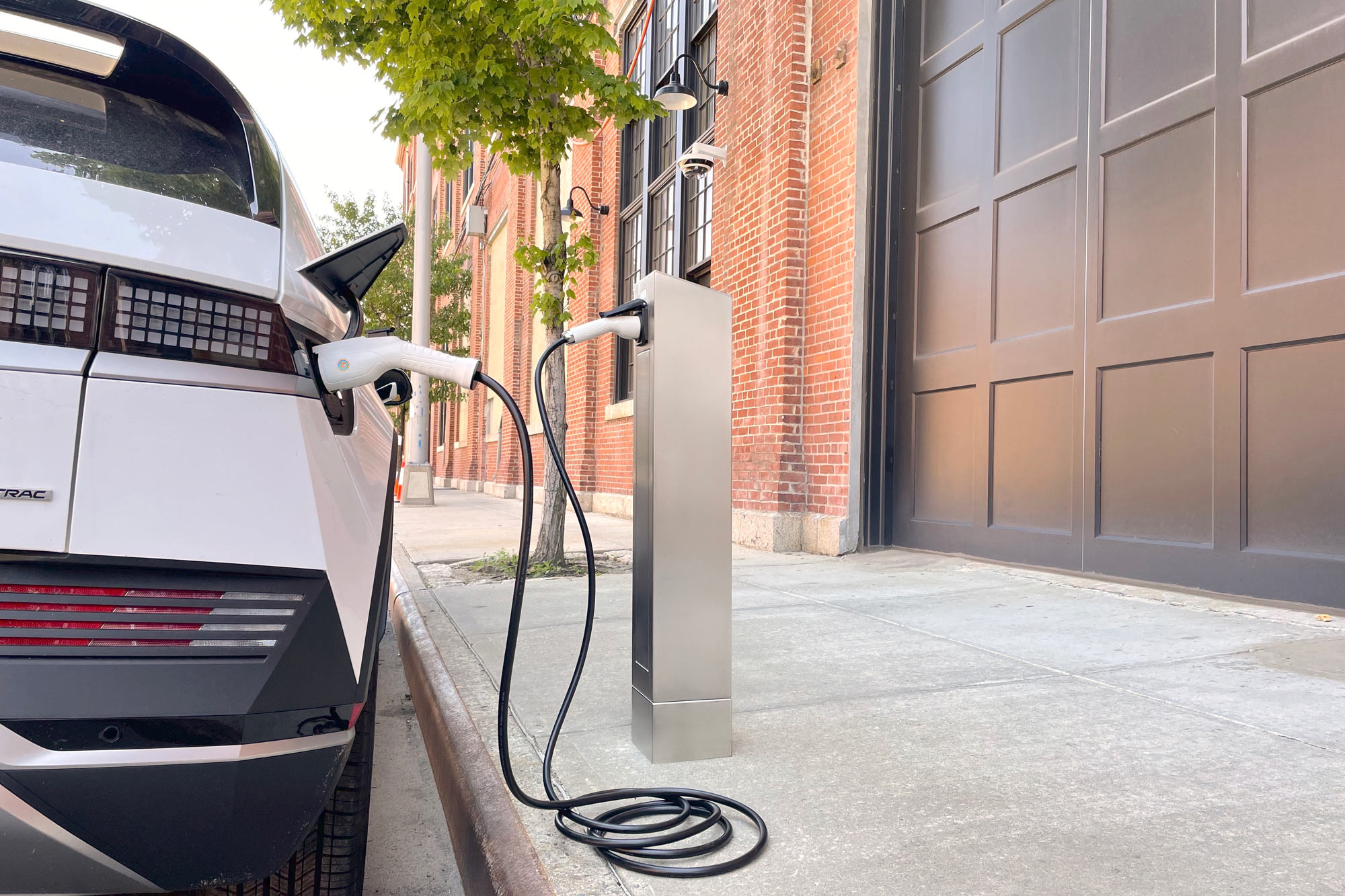 Hyundai vehicle plugged into itselectric curbside EV charger in New York