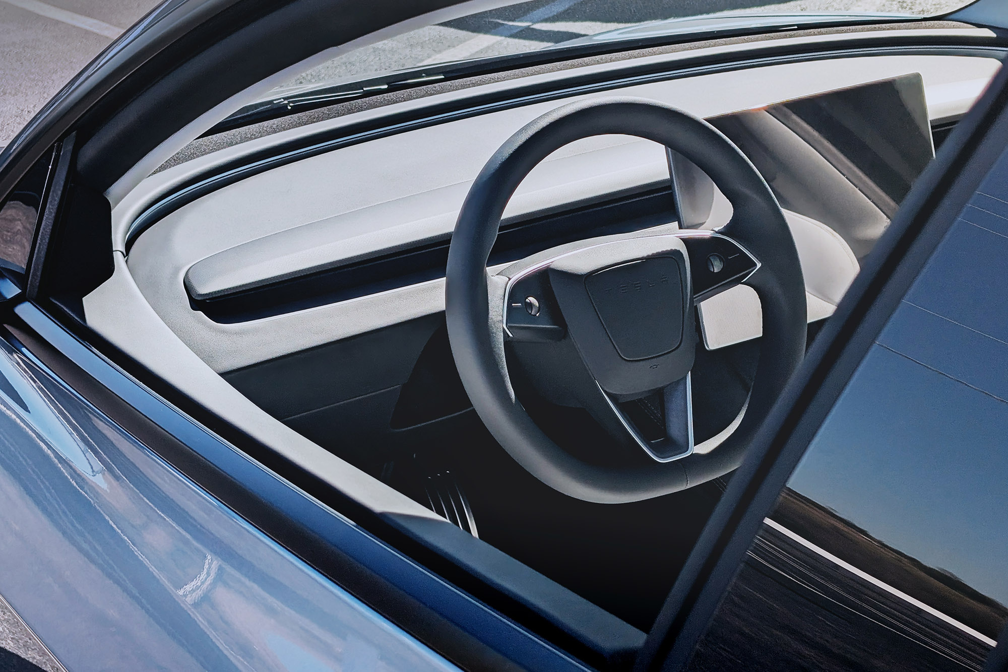 2025 Tesla Model 3 dashboard steering wheel and touchscreen seen through driver window