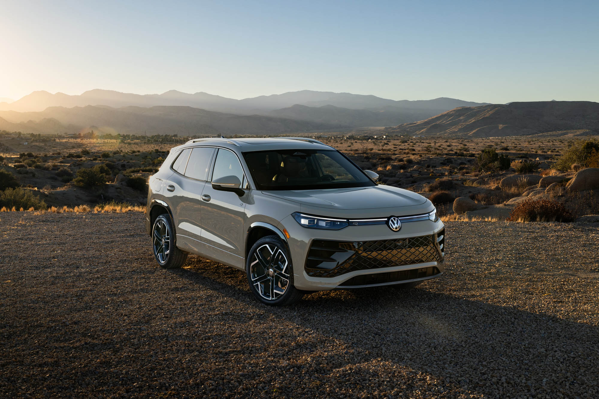 2025 Volkswagen Tiguan parked on gravel with mountains in the background