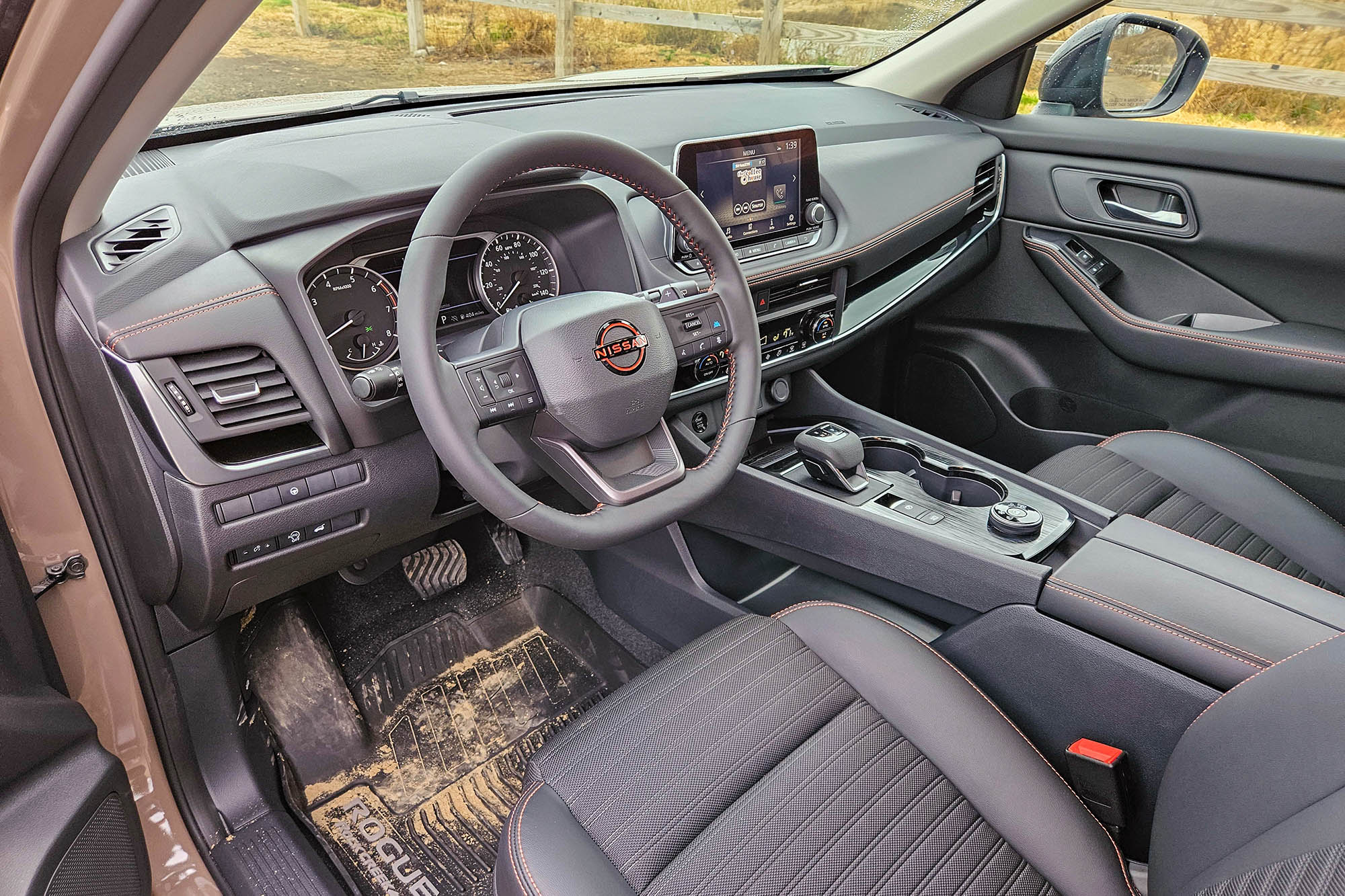 2025 Nissan Rogue Rock Creek interior in Charcoal with dirty all-weather floor mat