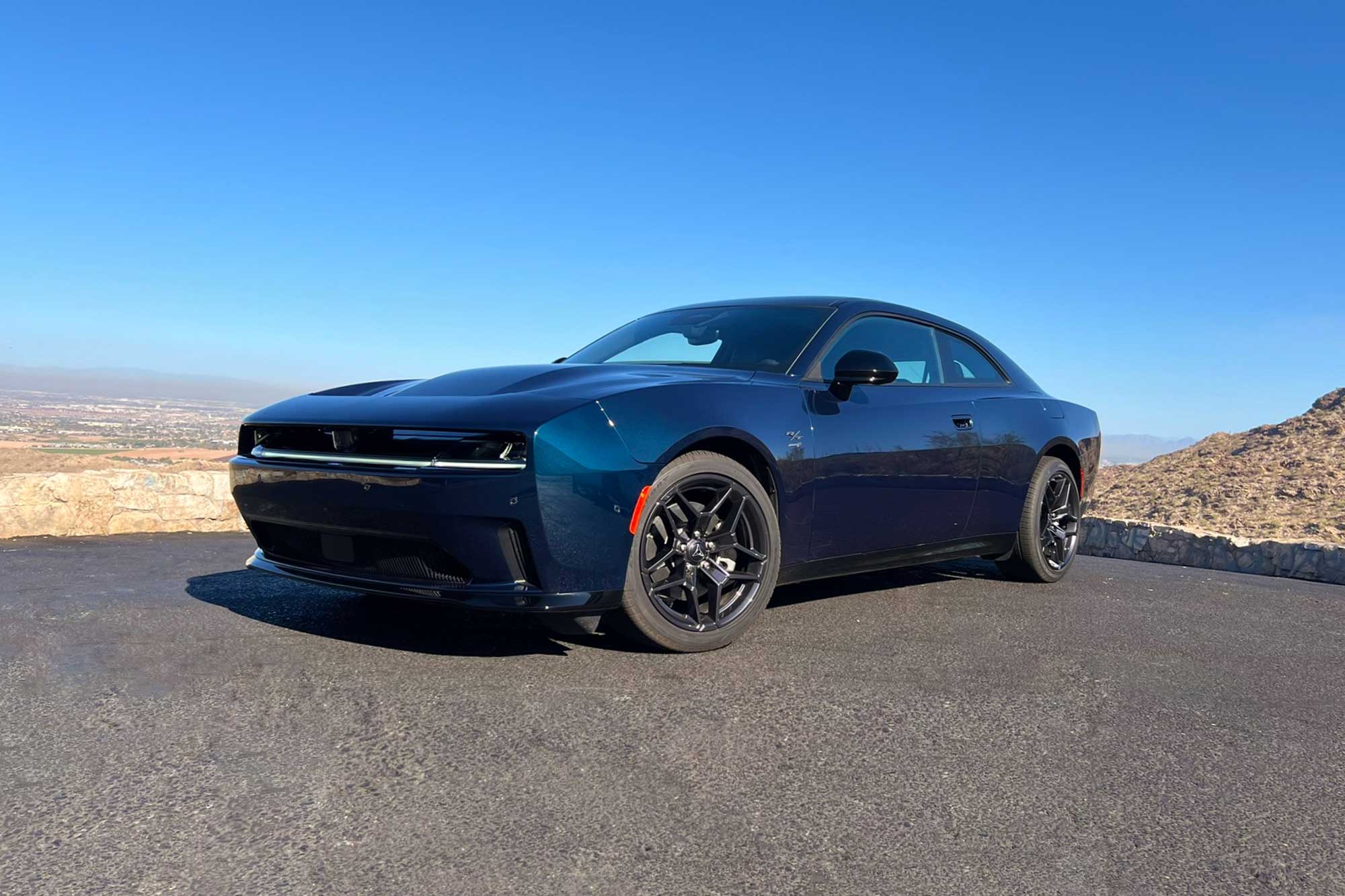 2024 Dodge Charger Daytona R/T in After Dark with the desert and blue skies in the background.