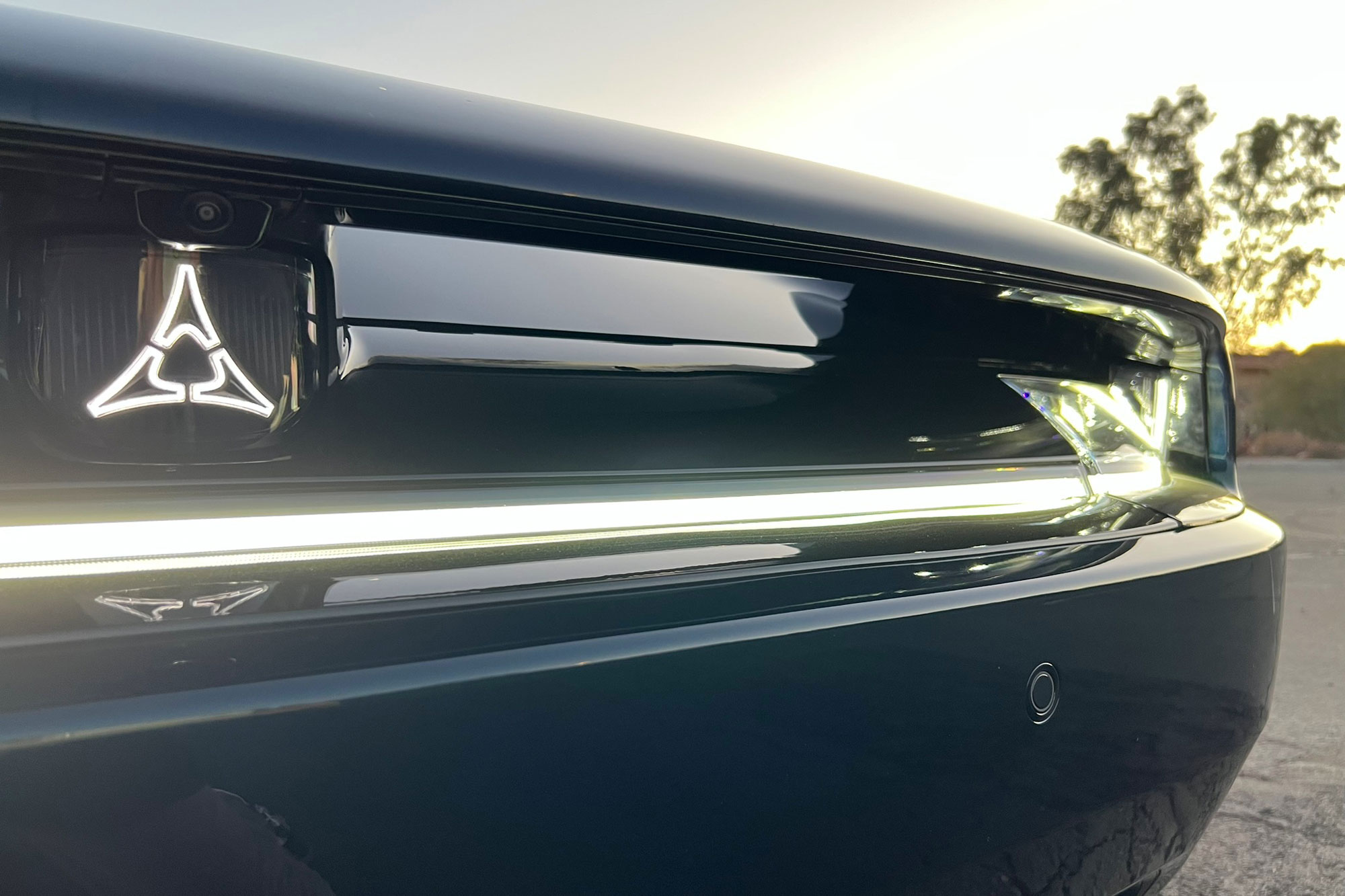 2024 Dodge Charger Daytona R/T Fratzog emblem illuminated at sunset.