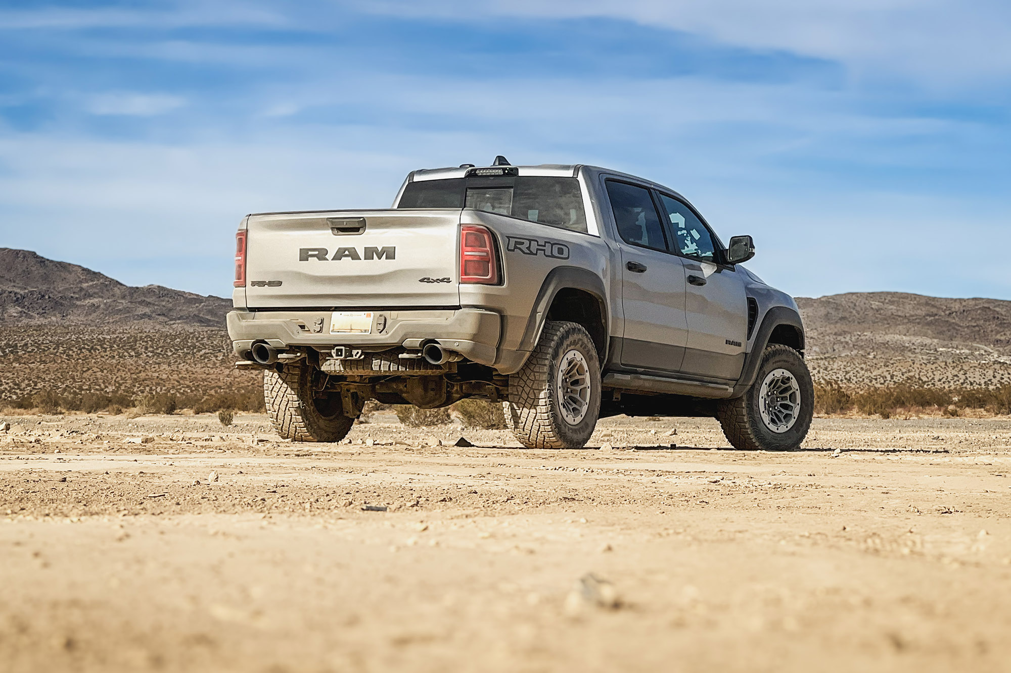 2025 Ram 1500 RHO in Billet Silver Metallic over Diamond Black Crystal Pearl parked in Johnson Valley, California, rear view