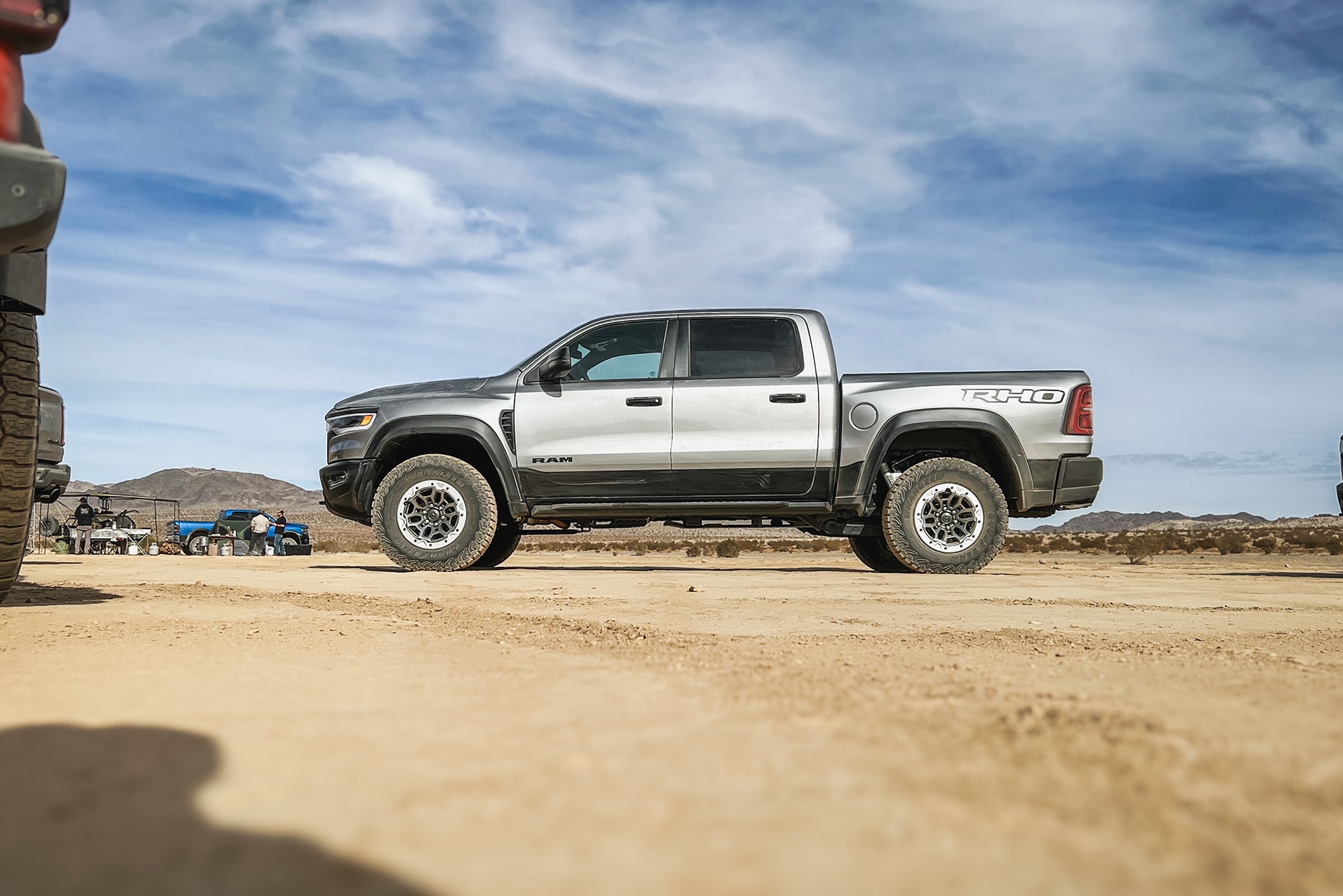 2025 Ram 1500 RHO in Billet Silver Metallic over Diamond Black Crystal Pearl parked in Johnson Valley, California, side view