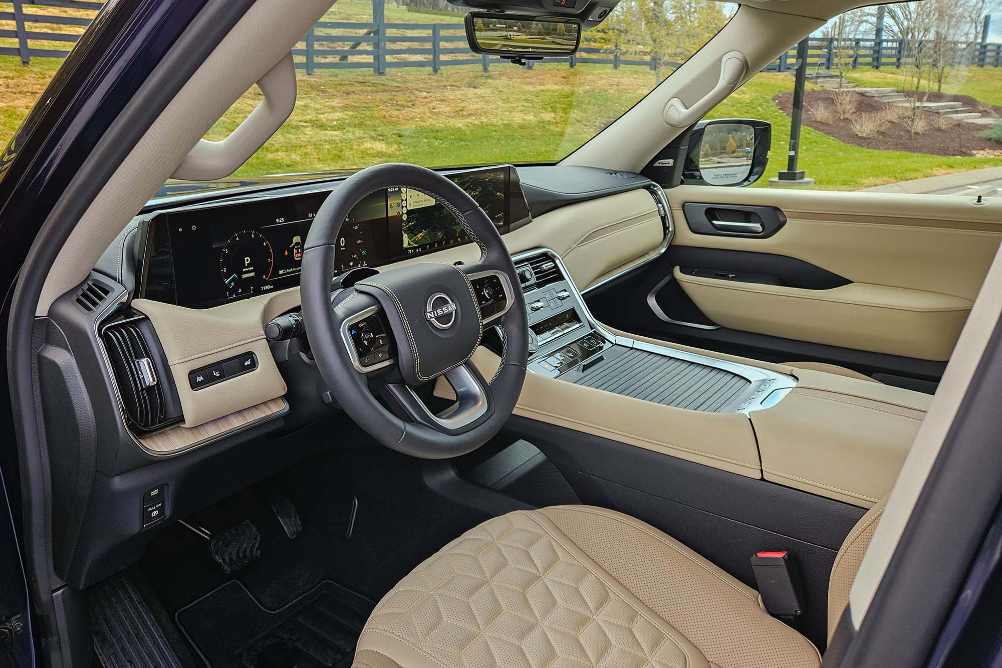 2025 Nissan Armada Platinum Reserve interior showing the dashboard, center console, and driver's seat.