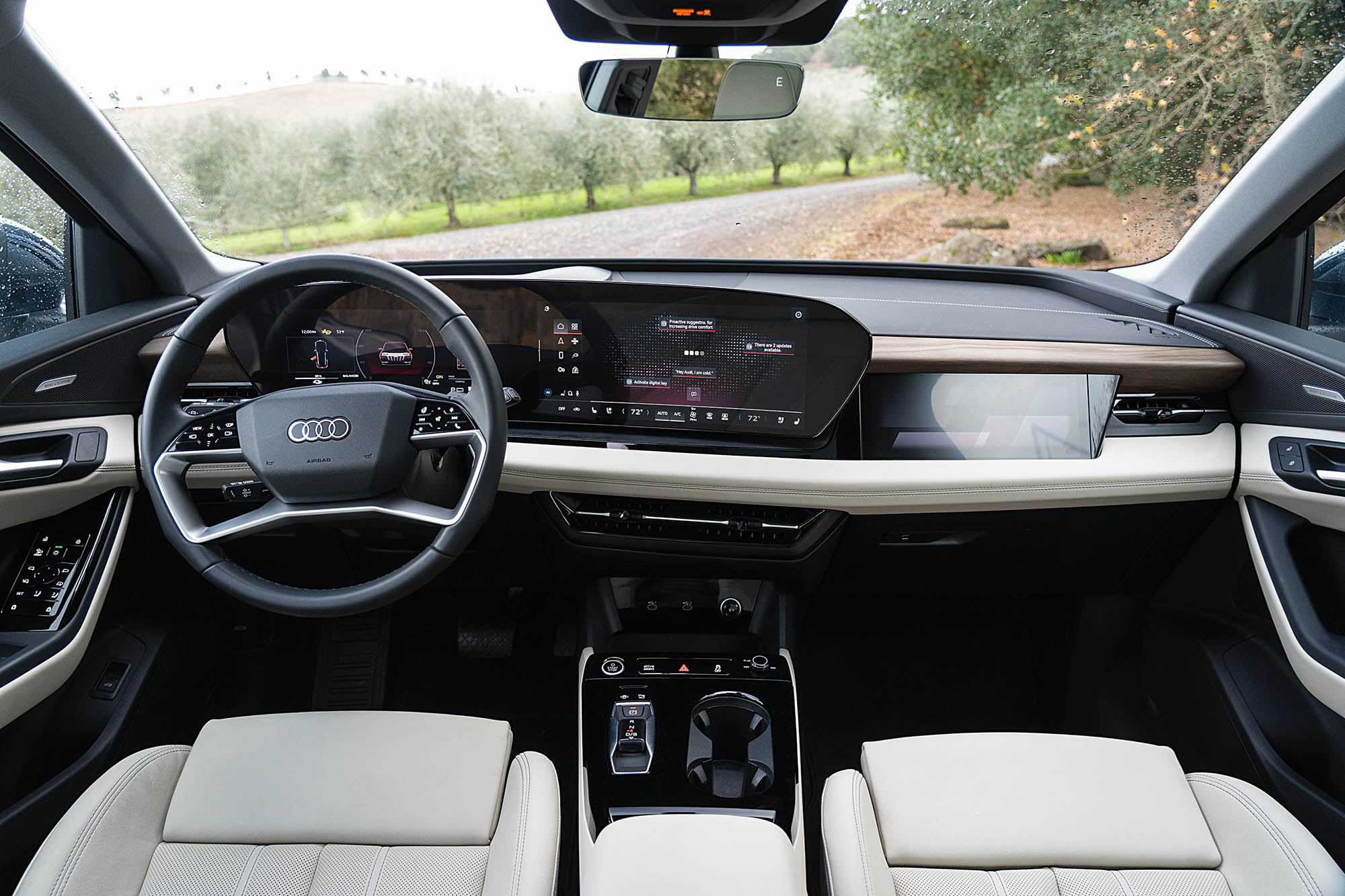 2025 Audi Q6 e-tron Prestige interior showing the dashboard, three display screens, center console, and front seats.